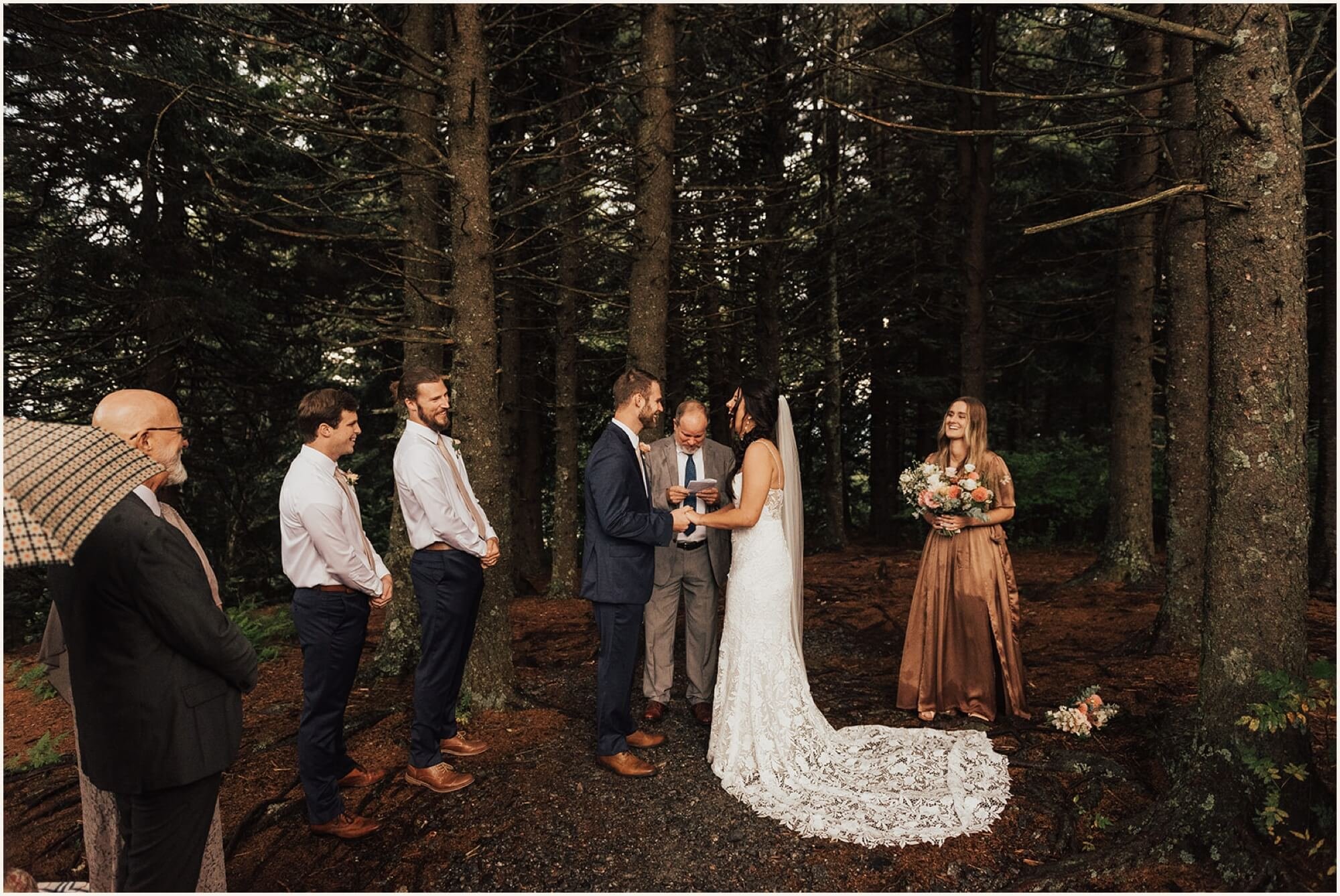 Bride and groom holding hands during ceremony in the Blue Ridge Mountains