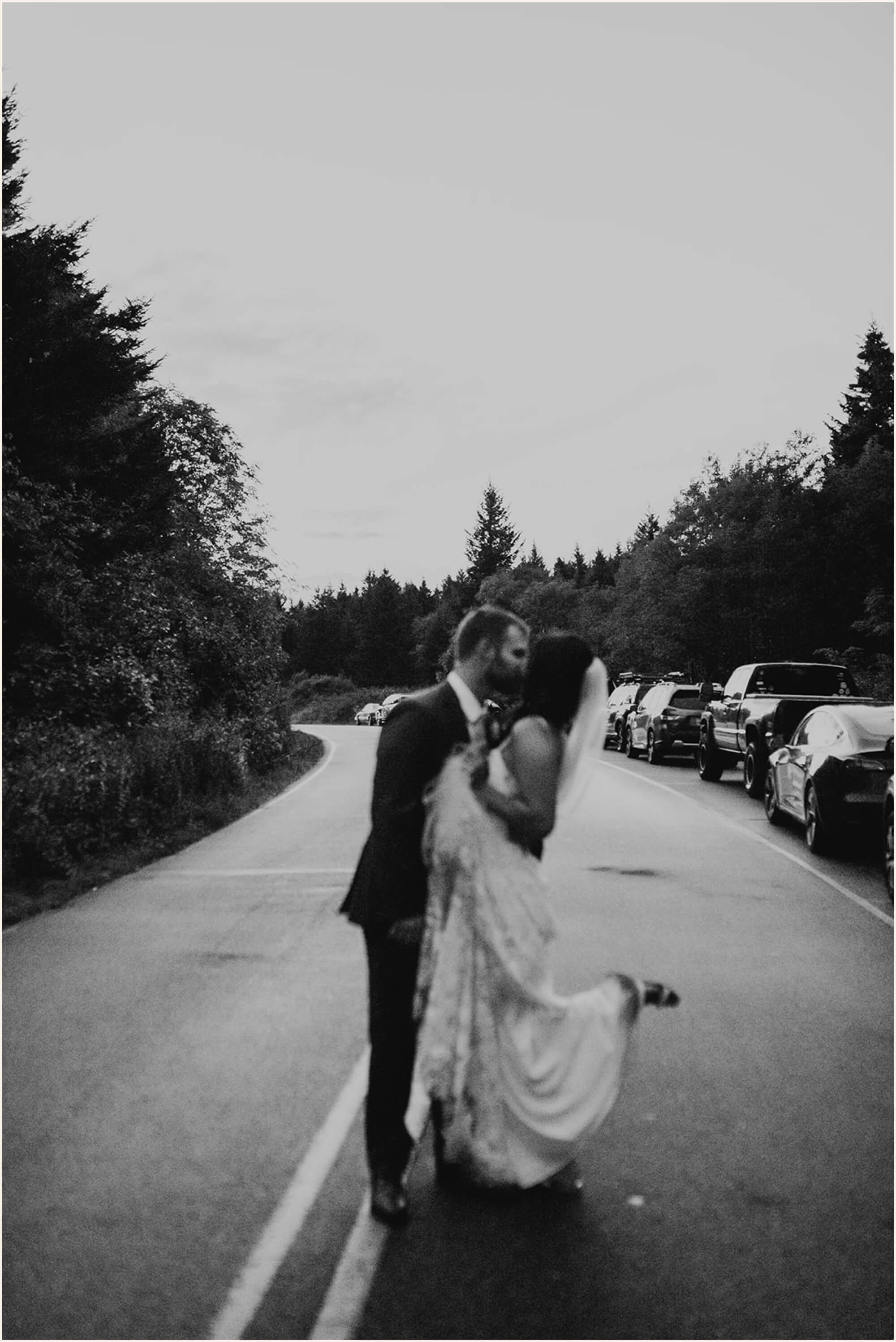 Bride and groom kissing in the middle of the road in the Blue Ridge Mountains