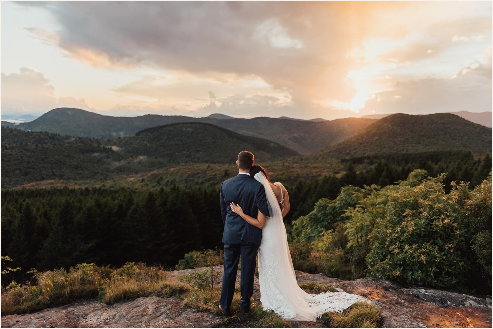 Bride and groom watching the sun set in the Blue Ridge Mountains
