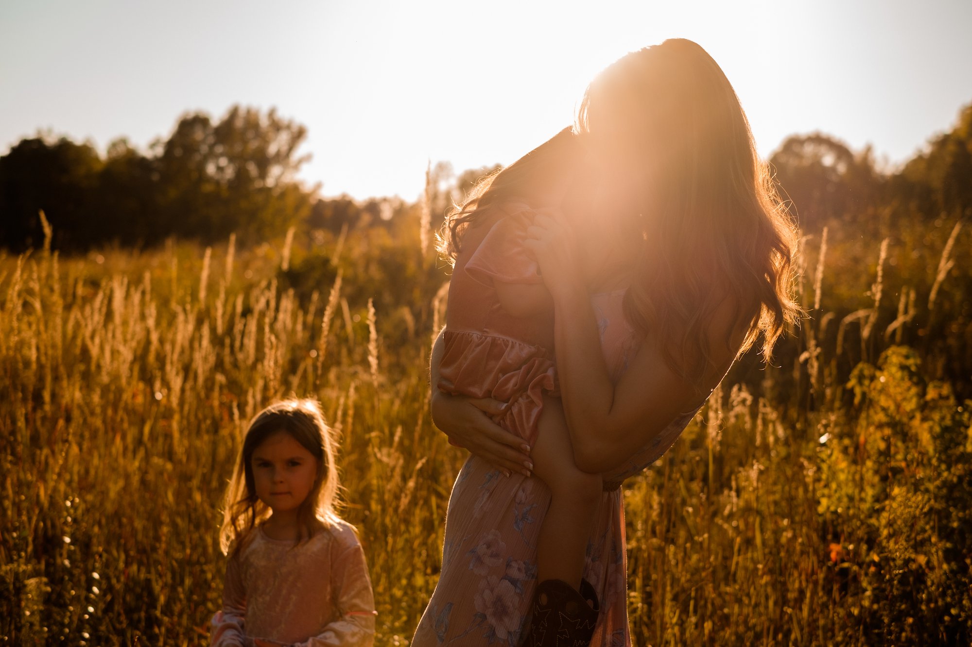 Photo of mother holding daughter in golden light