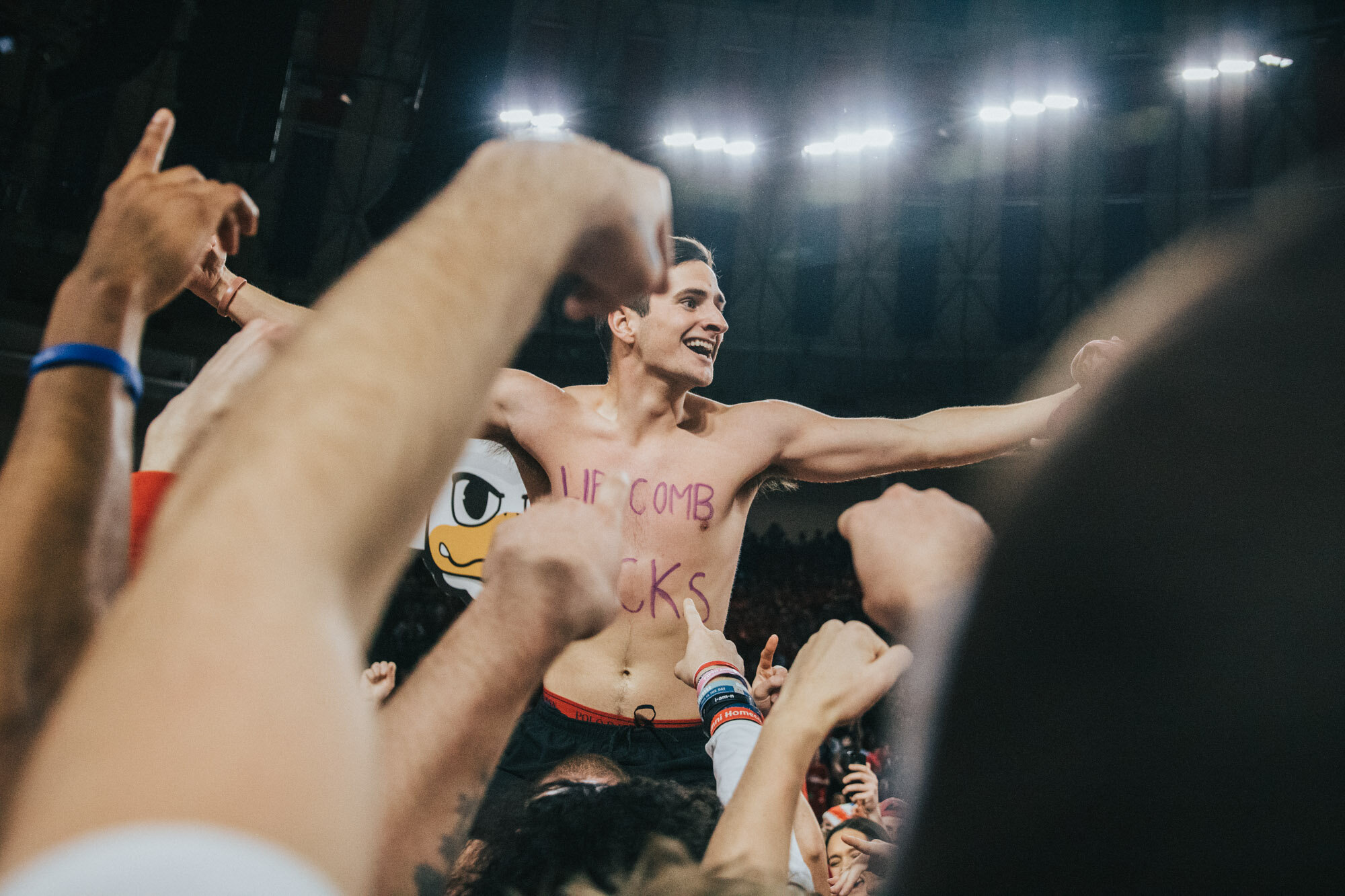 Students are photographed celebrating after a win for Liberty University's men's basketball team
