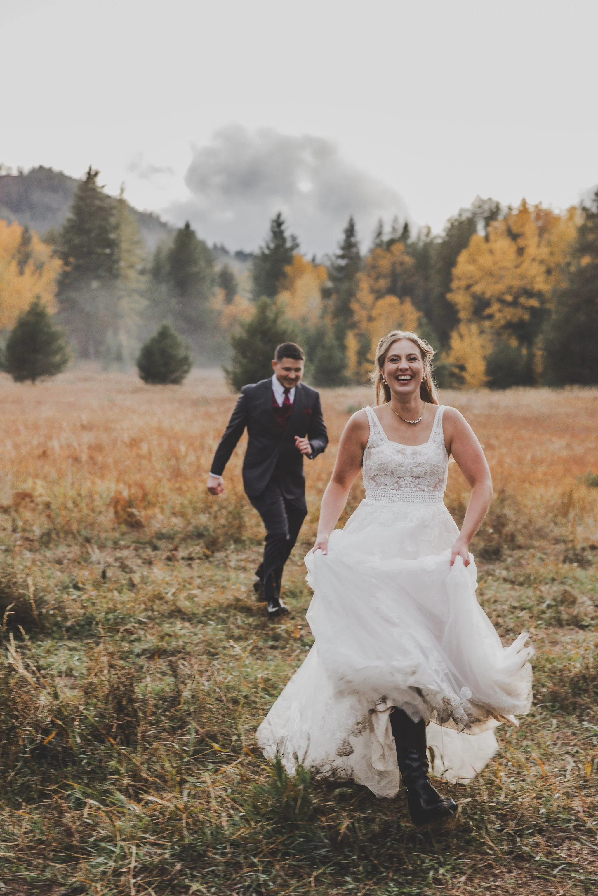 October fall wedding with bride running and laughing . full color wedding 
