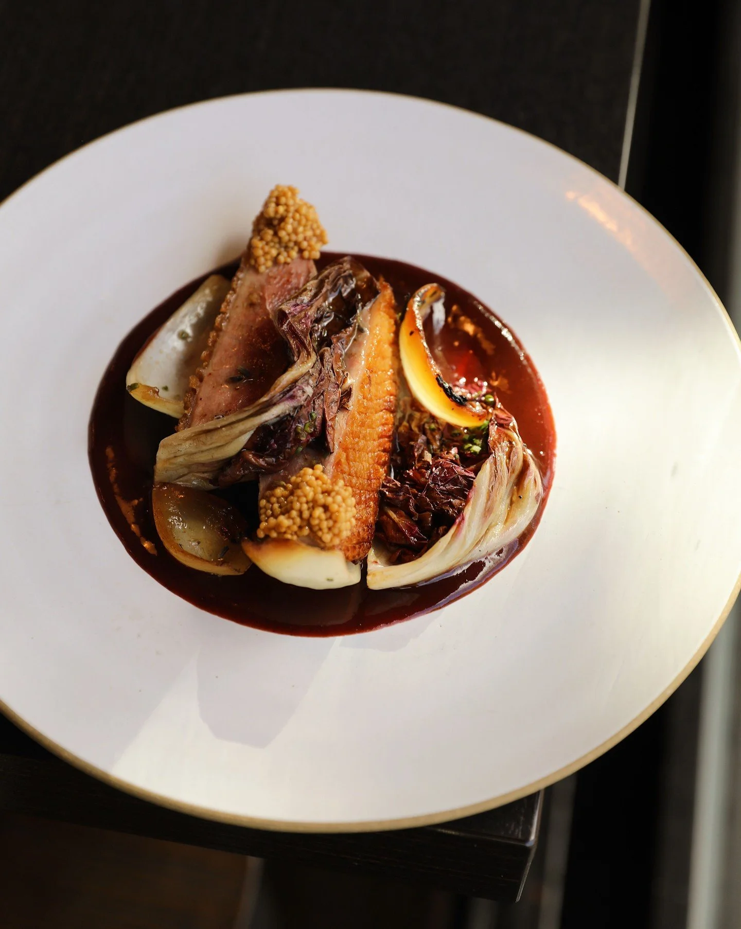 A new Autumn arrival for the season: beautiful duck breast, carved and broken down from whole duck and paired with a vibrant fermented plum chamoy (sauce). The plate comes alive with garnished radicchio, sweet charred Walla Walla onion, and the delic