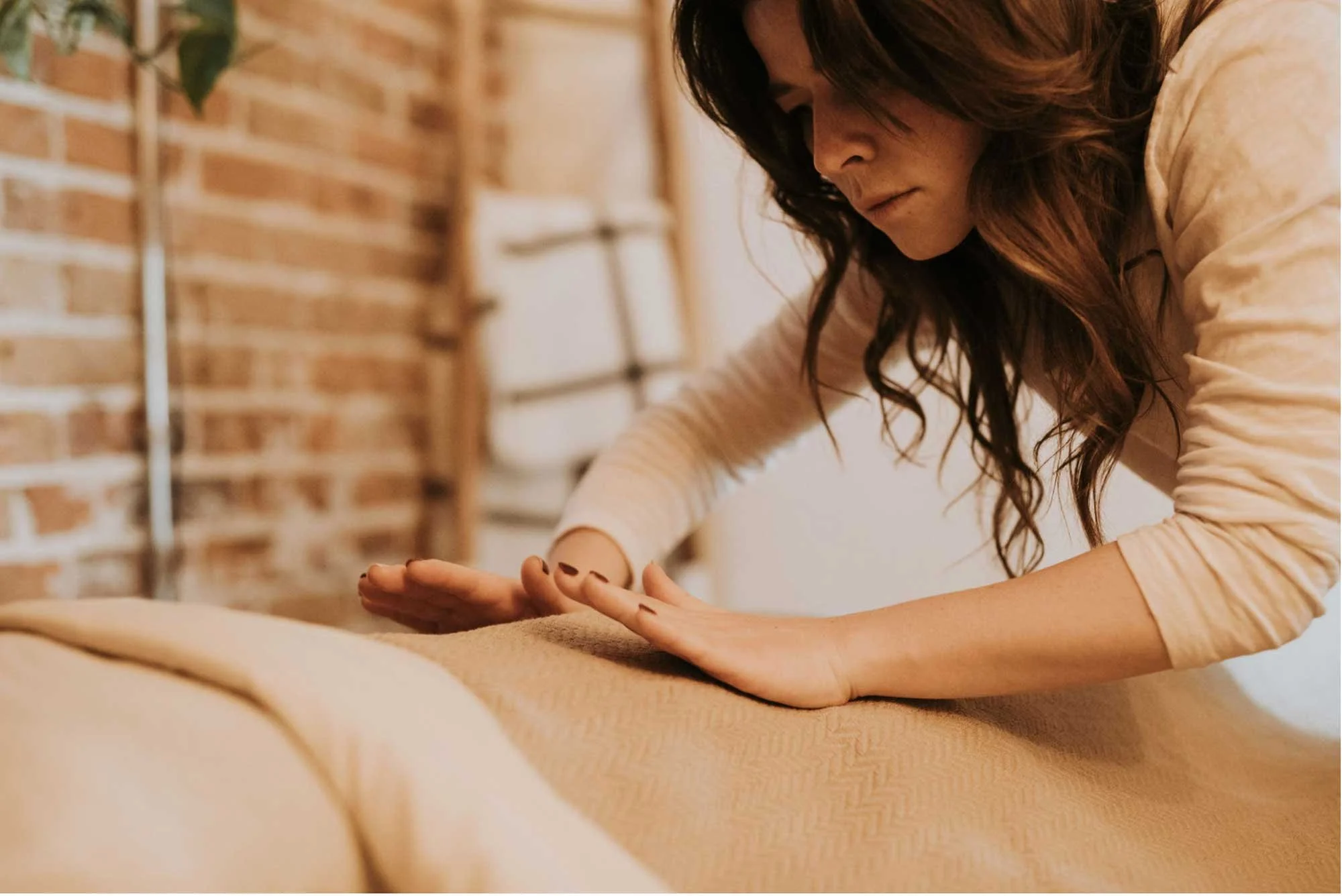 Reiki practitioner with table client