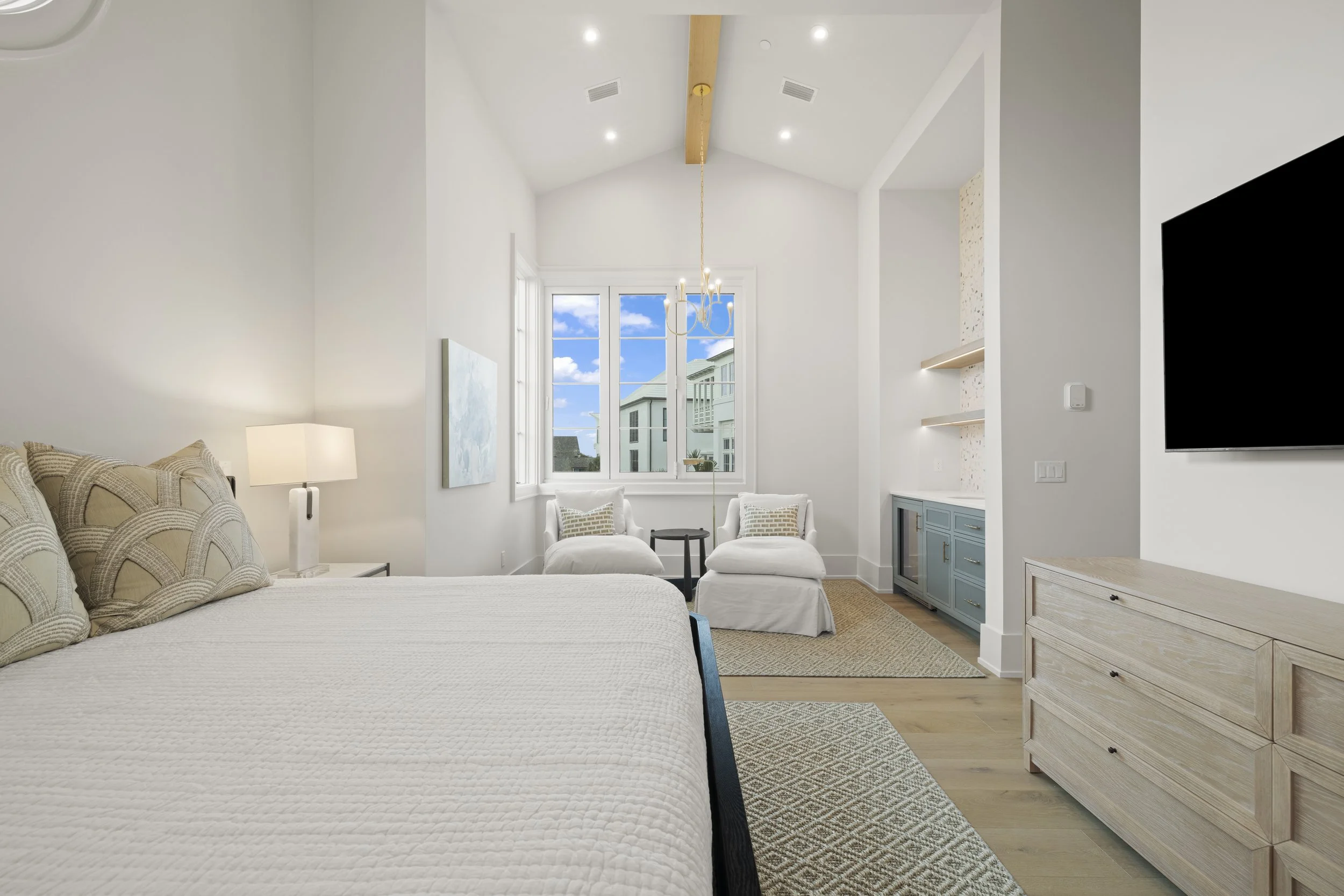 Grayton Beach real estate interior featuring functional layout, mounted TV, and rustic-modern dining style