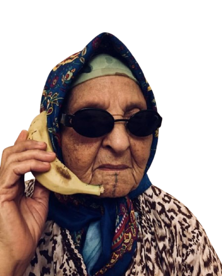 An elderly woman wearing dark sunglasses, a headscarf, and a patterned robe, holding a banana to her ear as if it were a phone.