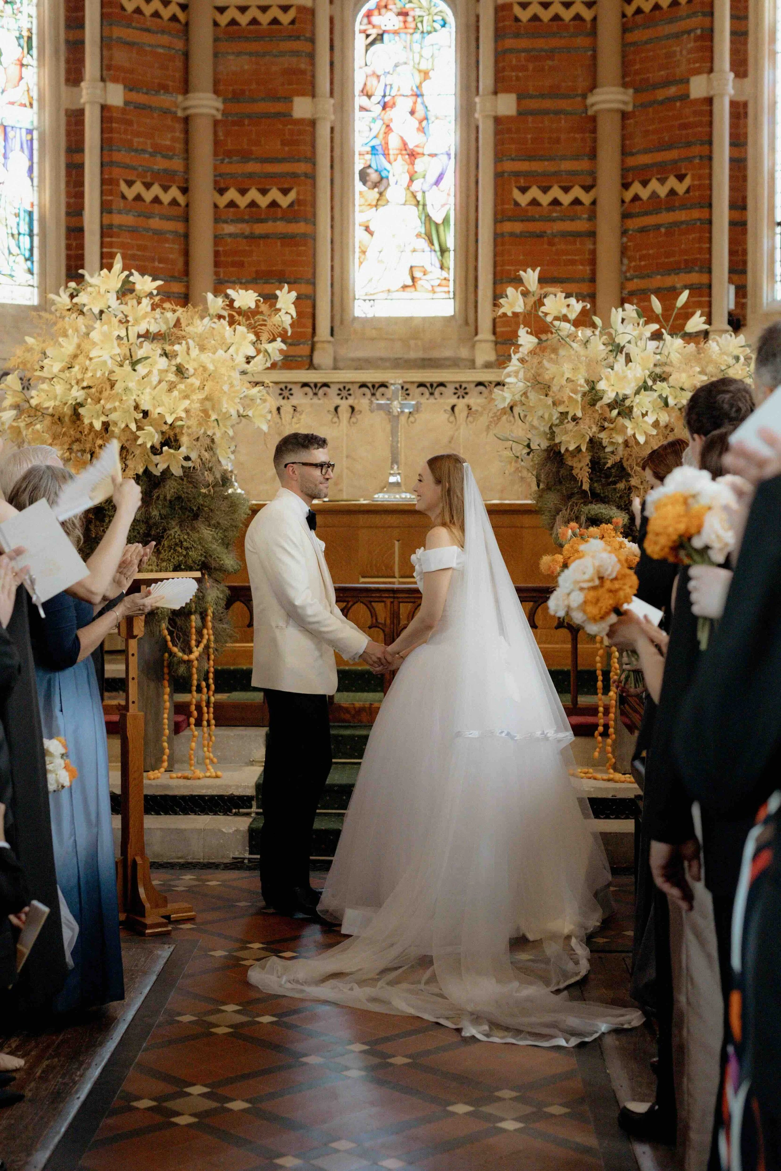 Large impactful urns of Lilies at the ceremony in London Highgate Chapel summer vintage wedding