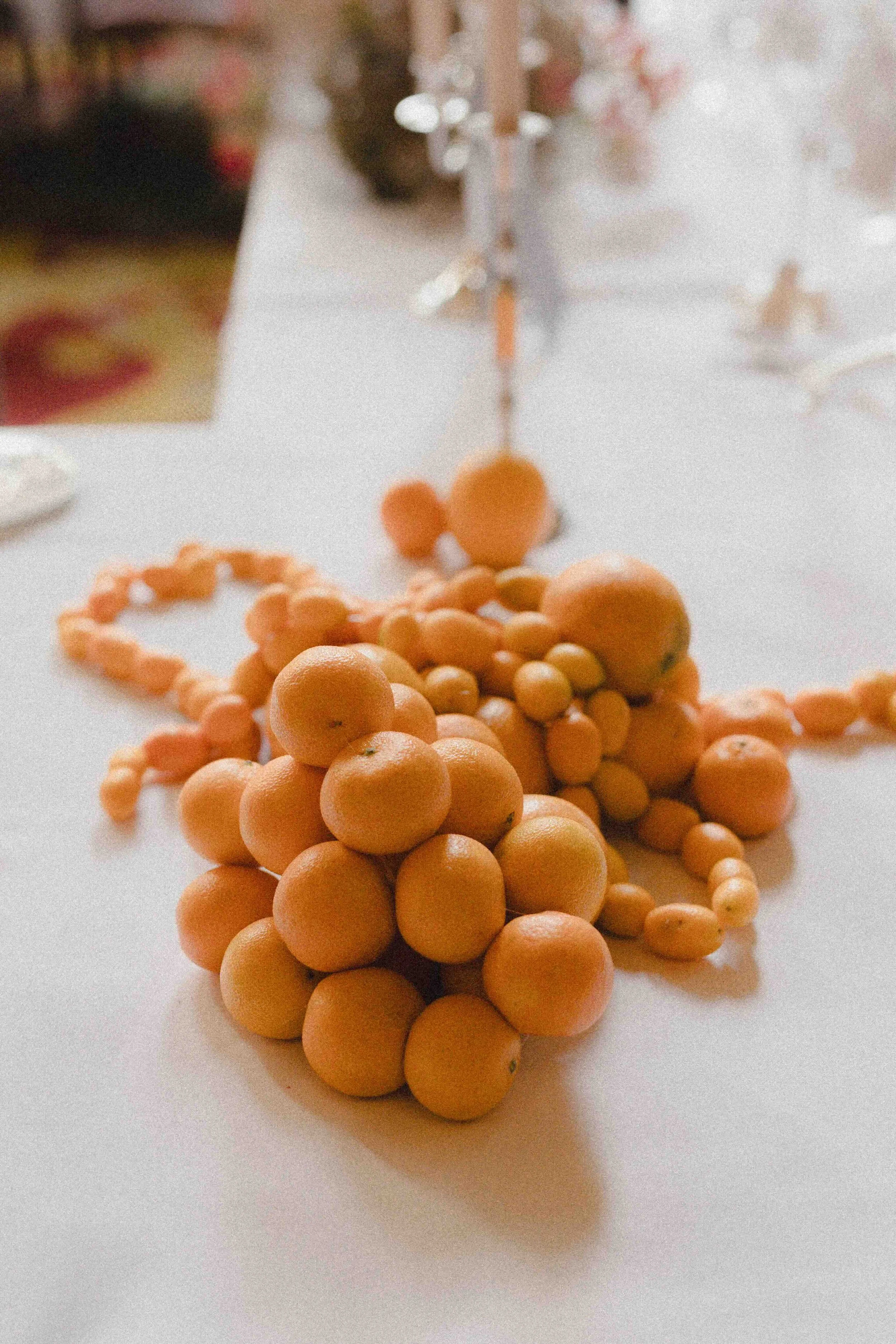 Expressive sculptural piles of citrus fruit for unusual floral design London summer wedding