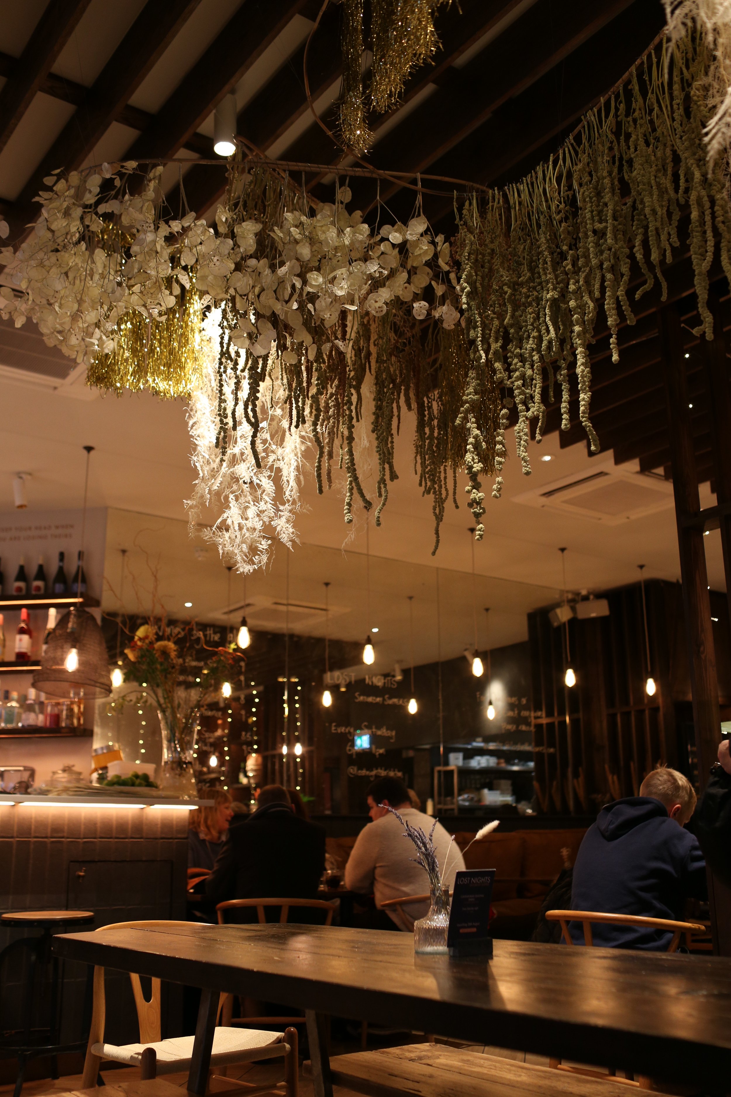 Dried flowers, seed heads and mixed media for large scale installation in coffee shop restaurant Brighton Sussex London large hanging installation