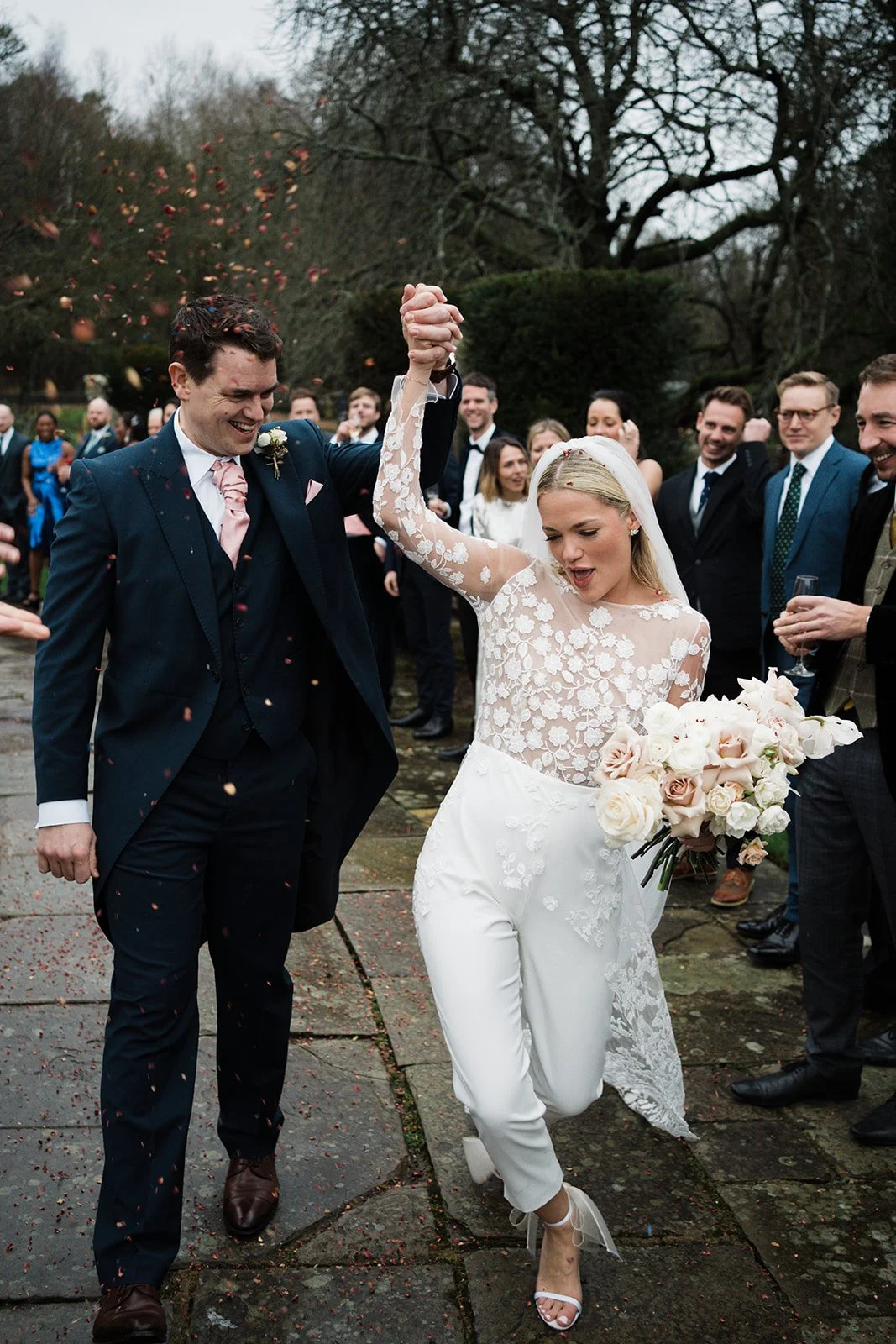 Modern bride and traditional groom celebrating at Port Lympne Kent London new years eve party celebration wedding roses orchids glam jimmy choo