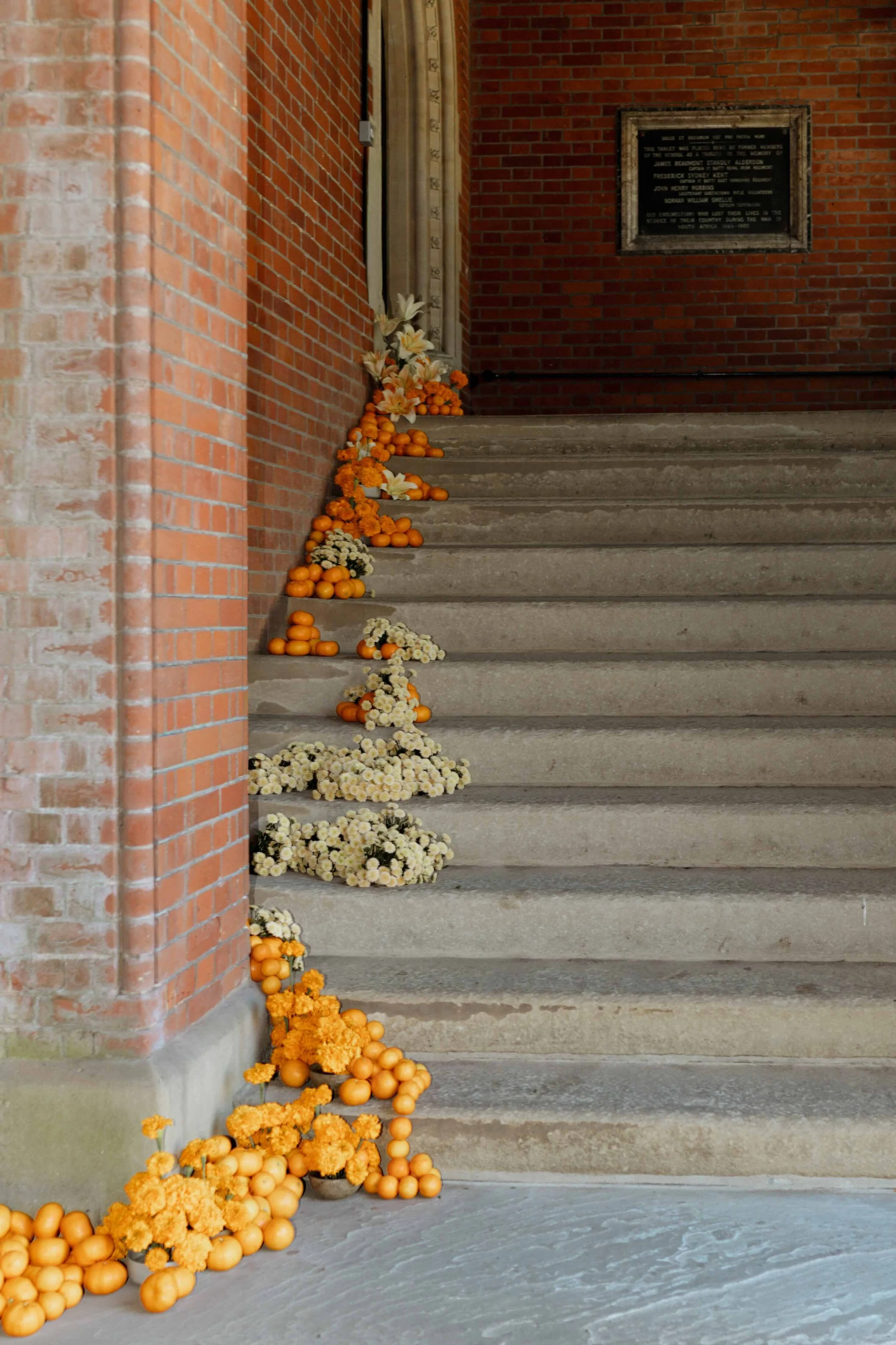 Oranges and flowers creating striking installation on the steps ready for ceremony at Highgate Chapel