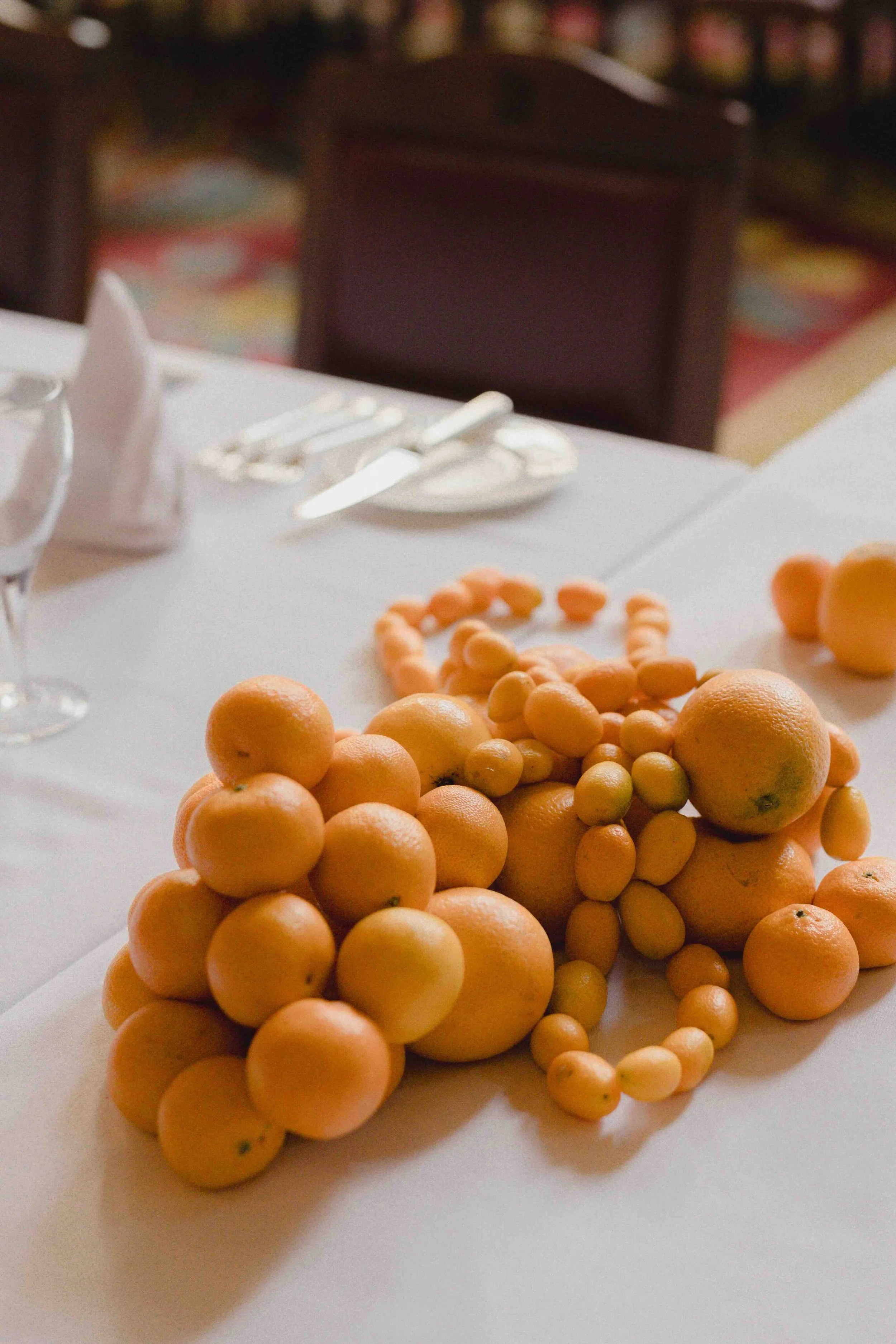 Expressive sculptural piles of citrus fruit for unusual floral design