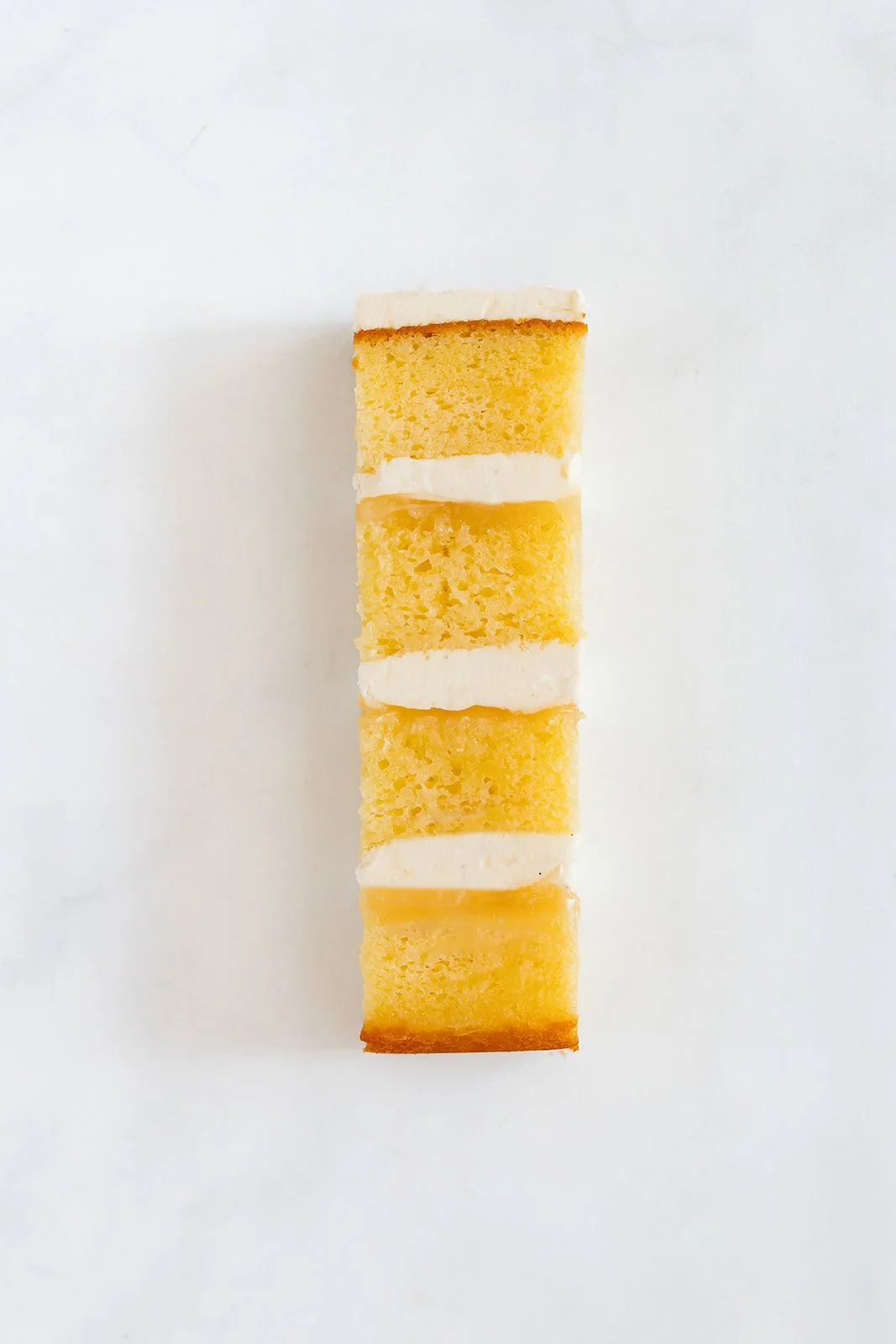 slice of lemon cake with lemon curd and lemon buttercream
