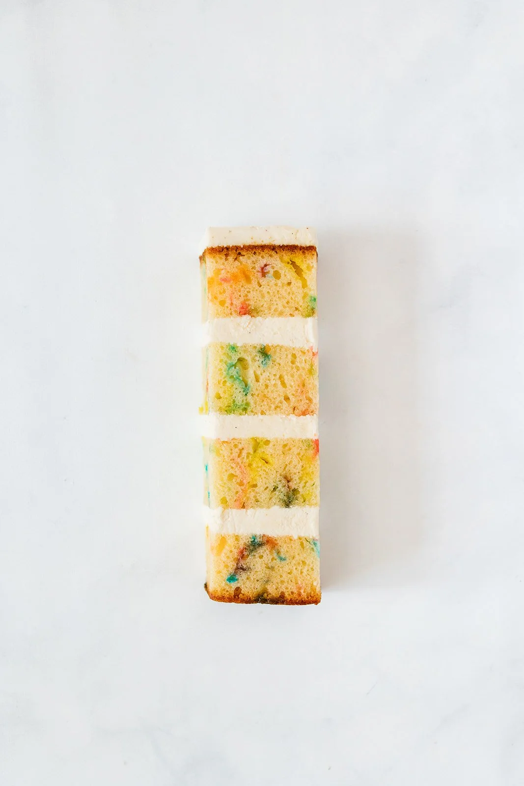 slice of confetti cake with cake batter buttercream