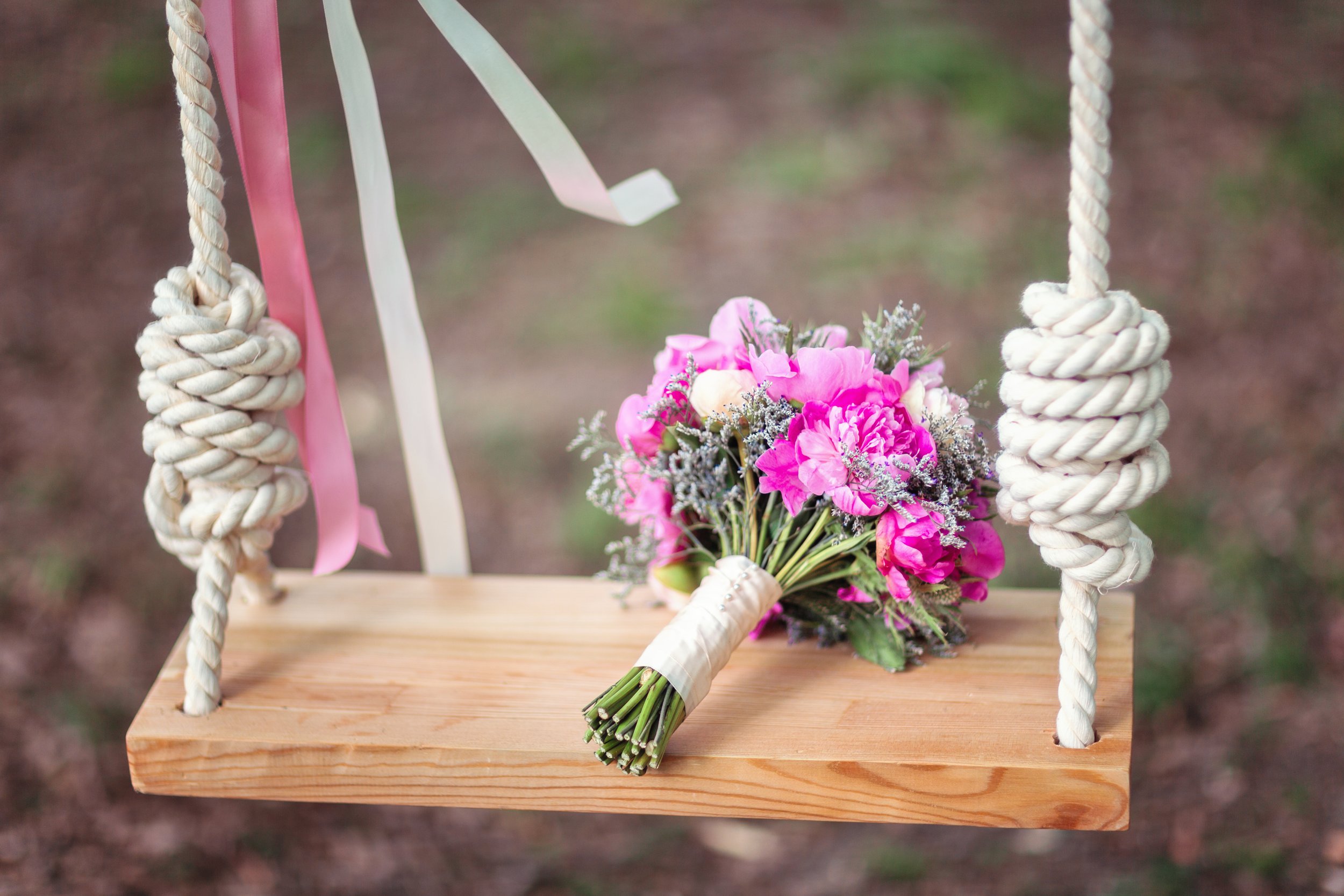 Pink bouquet on wooden swing.jpg