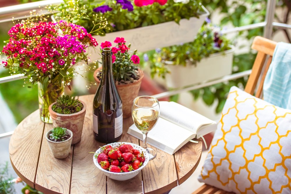 Reading on Balcony with Wine and Flowers.jpg
