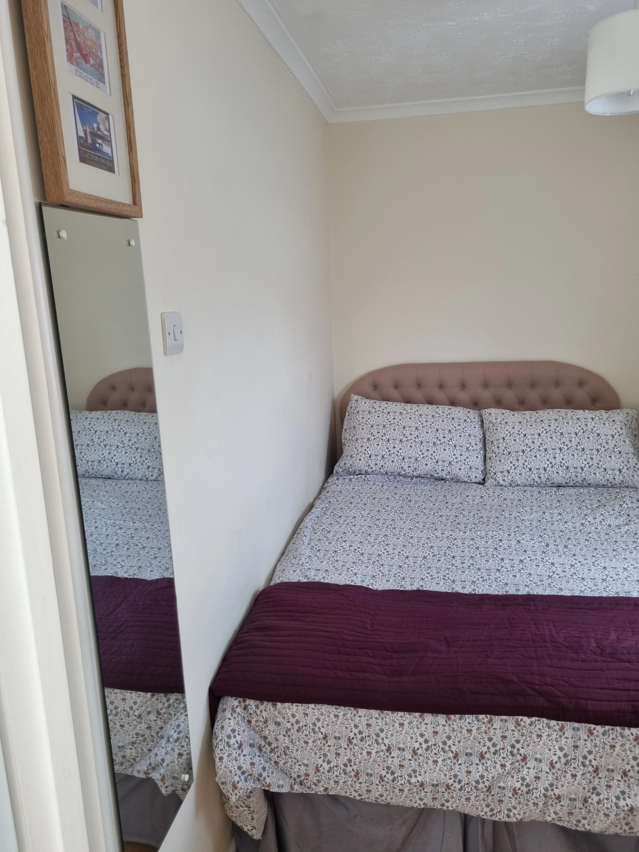 Bedroom with long mirrow.  Note the double bed is against the wall on one side in this cottage. 