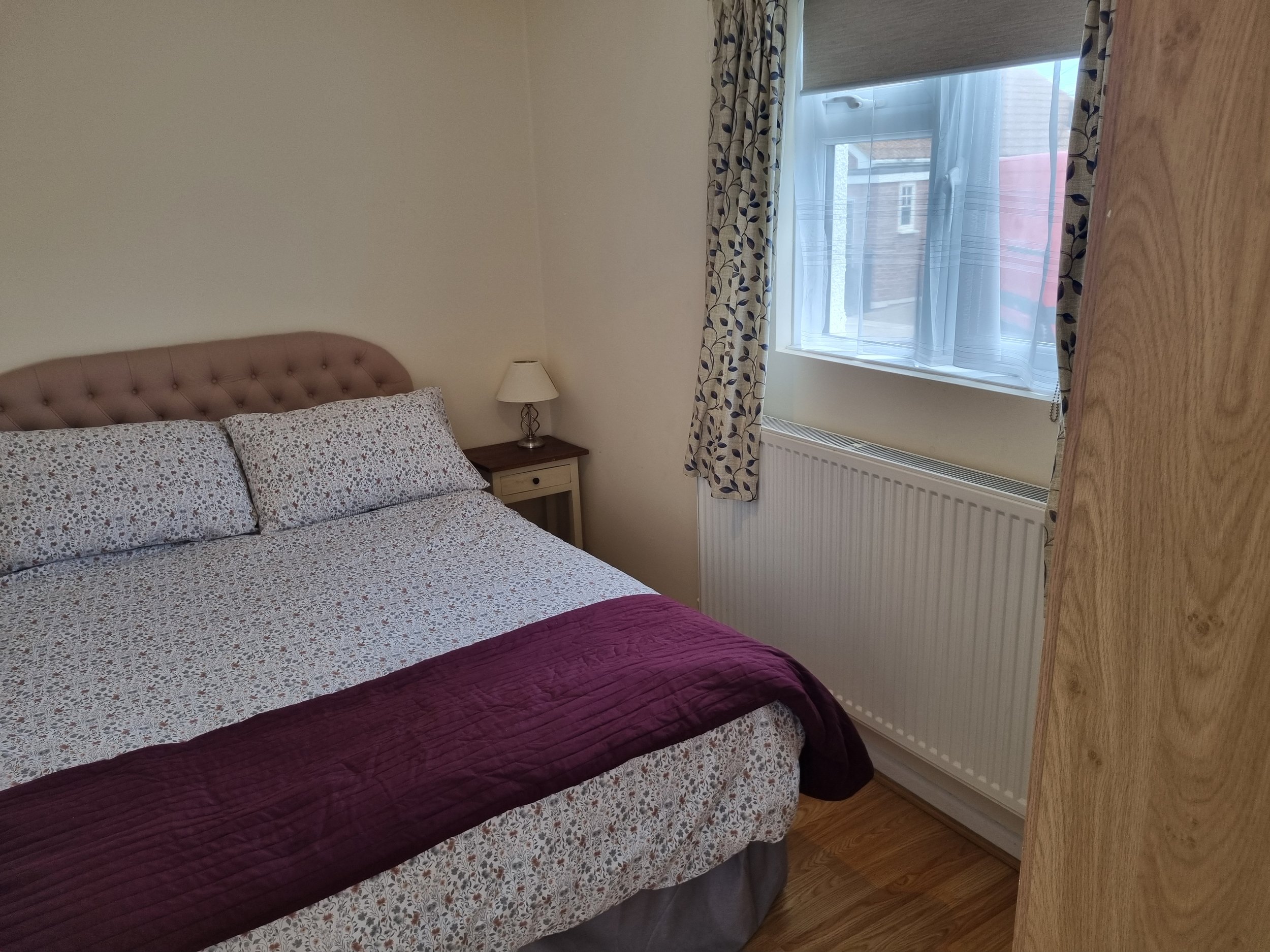 Bedroom with double bed and wardrobe 