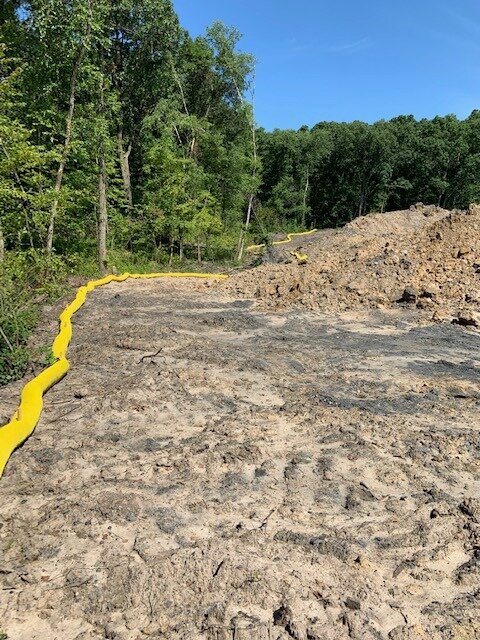 Custom yellow color etube filter sock installed along the perimeter of a project.