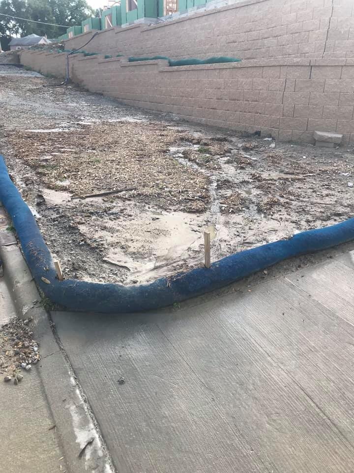 etube filter sock installed along the back of a curb to prevent sediment from washing out onto the pavement.