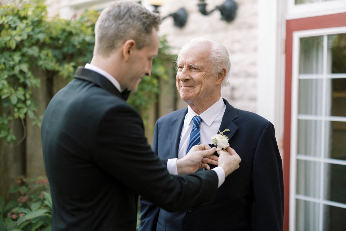 Groom pinning a boutonniere on his father for his Niagara-on-the-Lake wedding