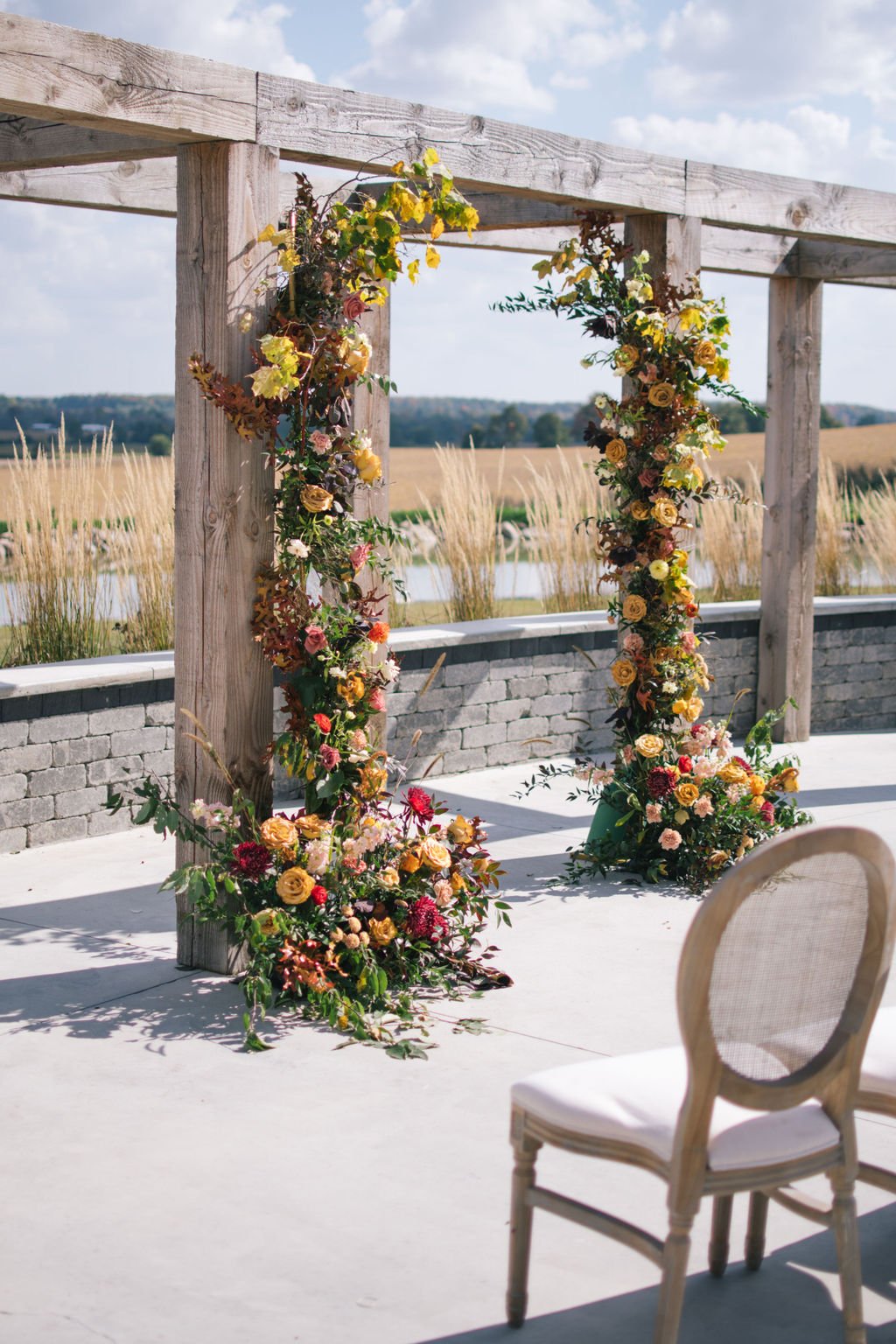 Fall inspired floral arch on wood structure at Wakefield Estate.