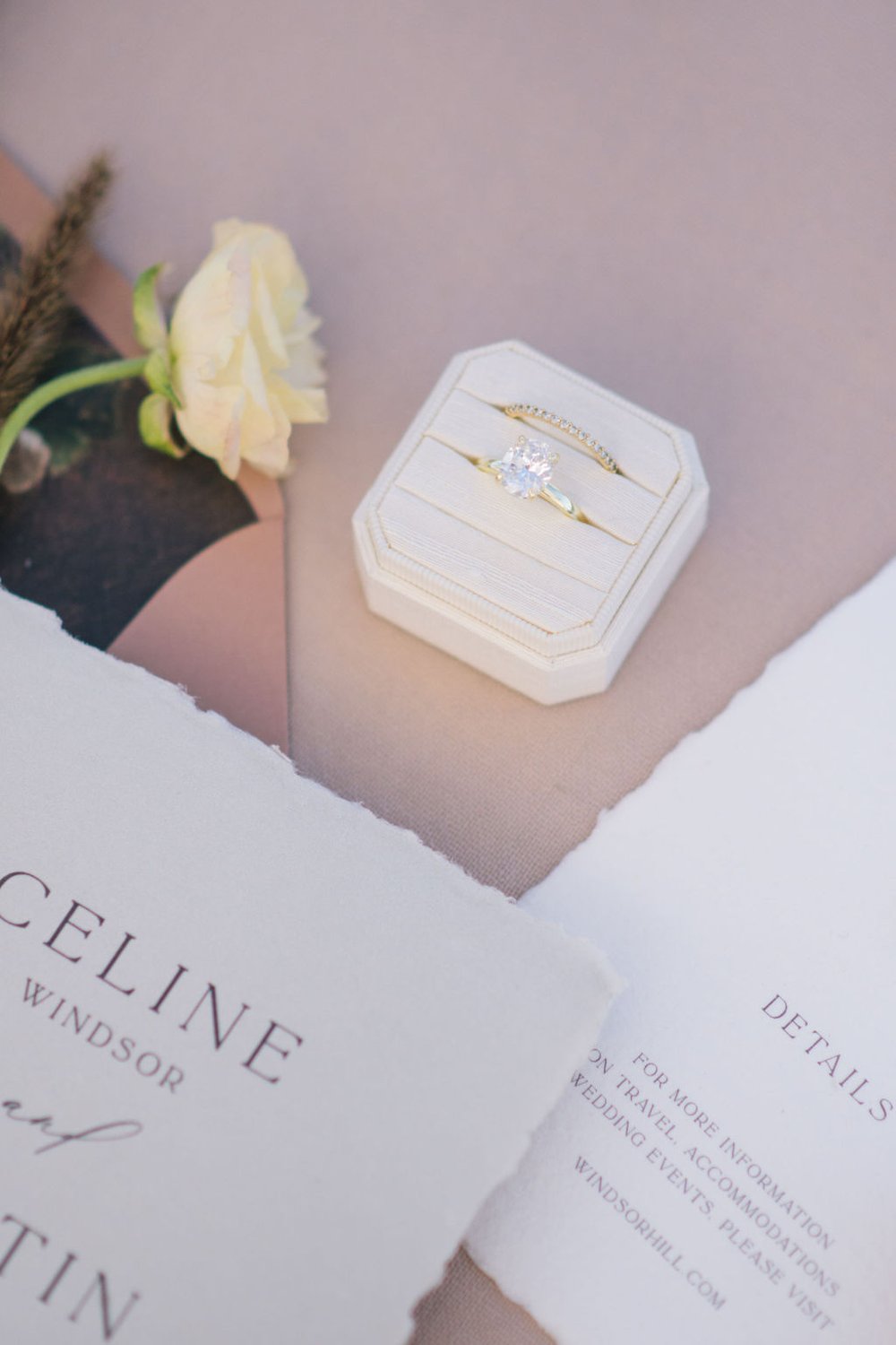 Gold solitare ring in Mrs Box in linen design complimented by custom invitation by Paper Palette.