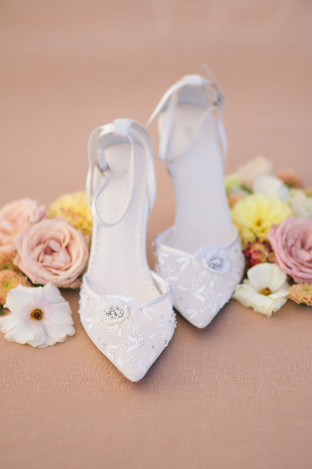 Bella Belle wedding shoes in a bed for fresh florals captured by Ugo Photography.