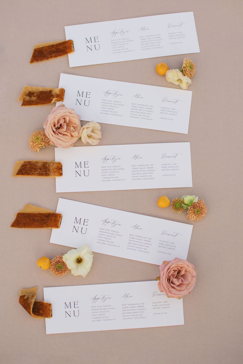 Custom wedding menu cards designed by Paper Palette with brunt orange velvet ribbon accents.