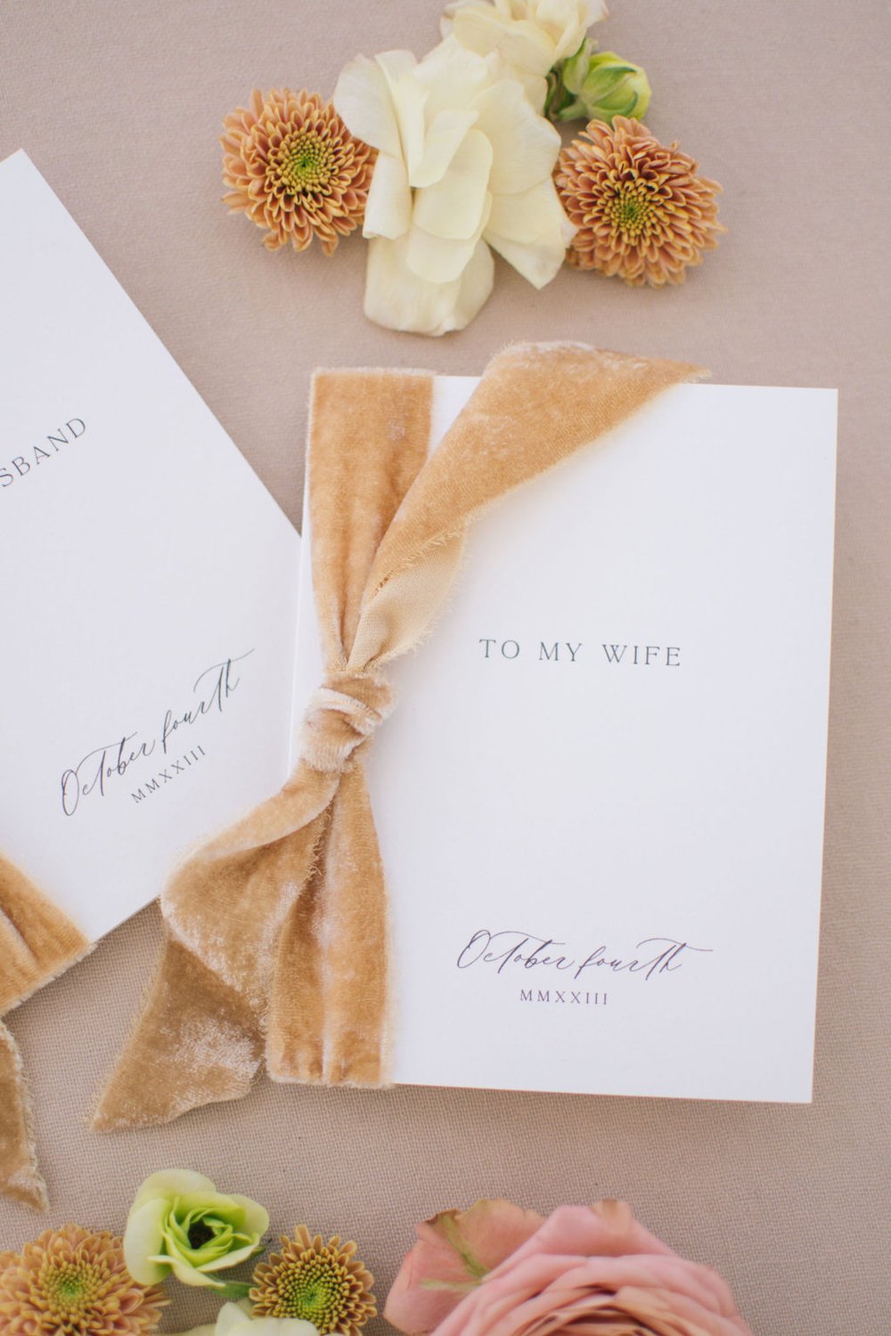 Custom vow books with velvet ribbon created by Paper Palette.