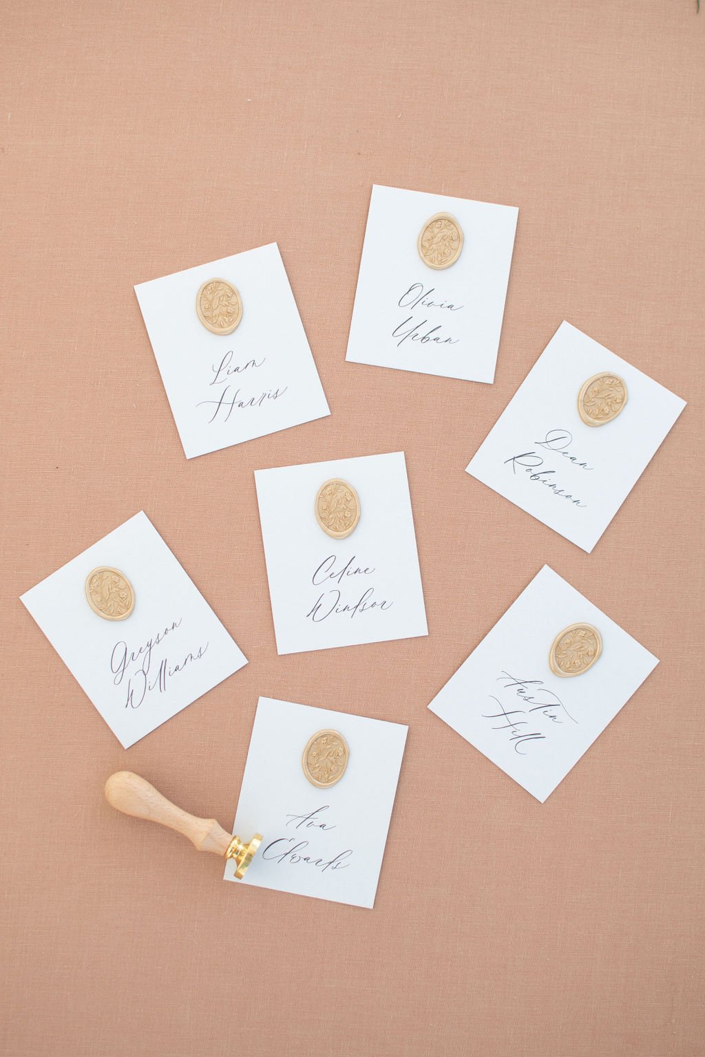 Custom wedding place cards with gold wax by Paper Palette.