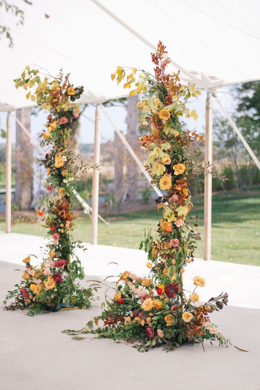 Fall colour palette from MacRose Design with floral pillars to compliment the sailcloth tent at Wakefield Estate.