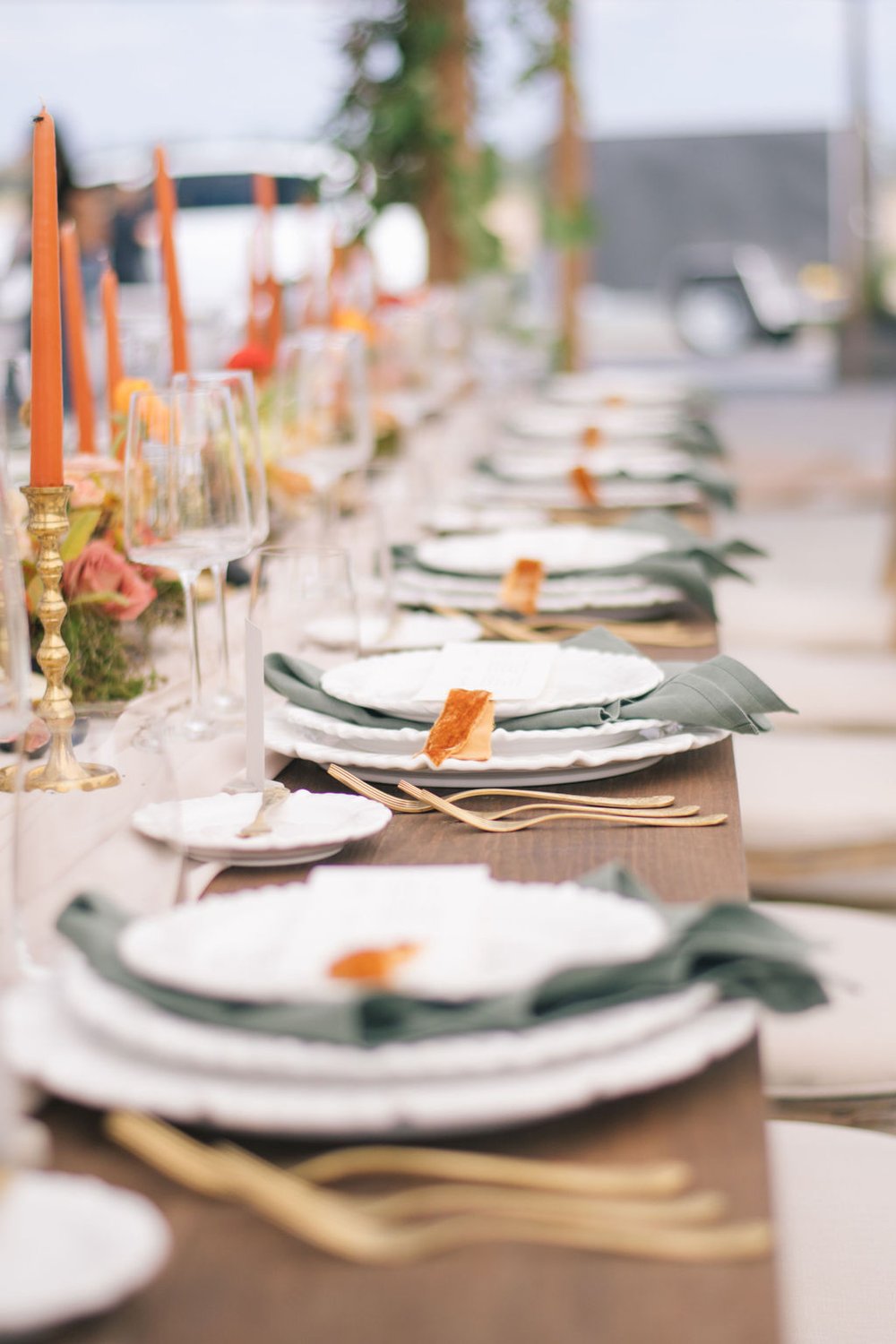 Tabletop rentals from Simply Beautiful Decor with olive green napkins and gold floral cutlery.