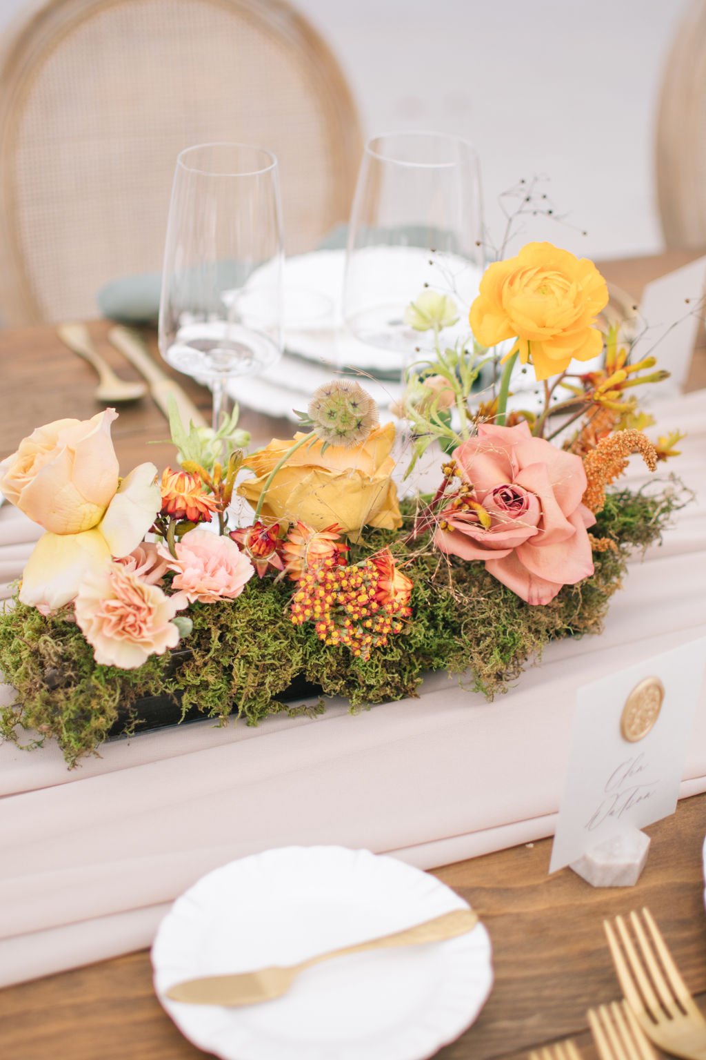Floral meadows centred down the harvest tables on taupe chiffon table runners.