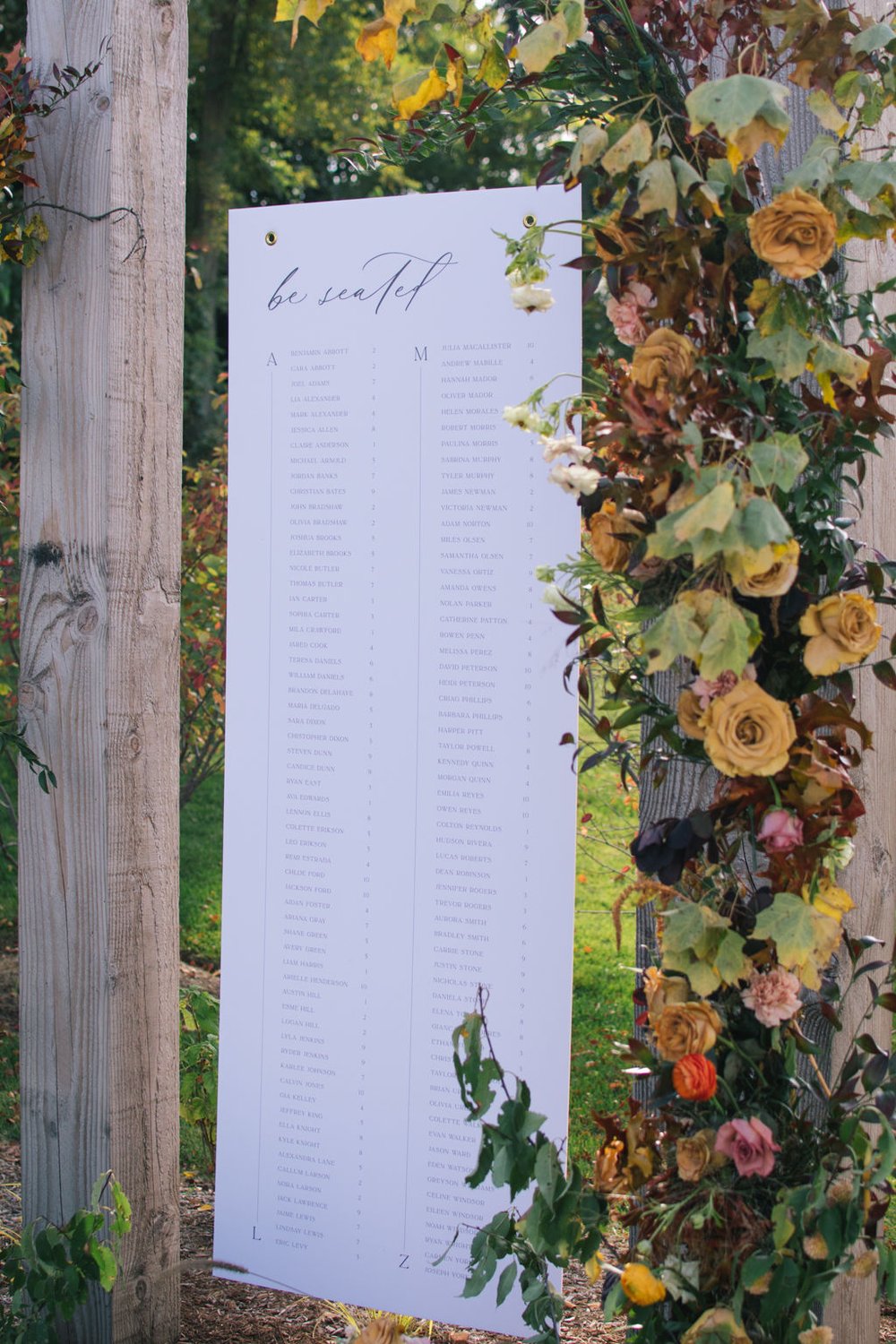 Hanging seating chart with custom floral display at Wakefield Estate.