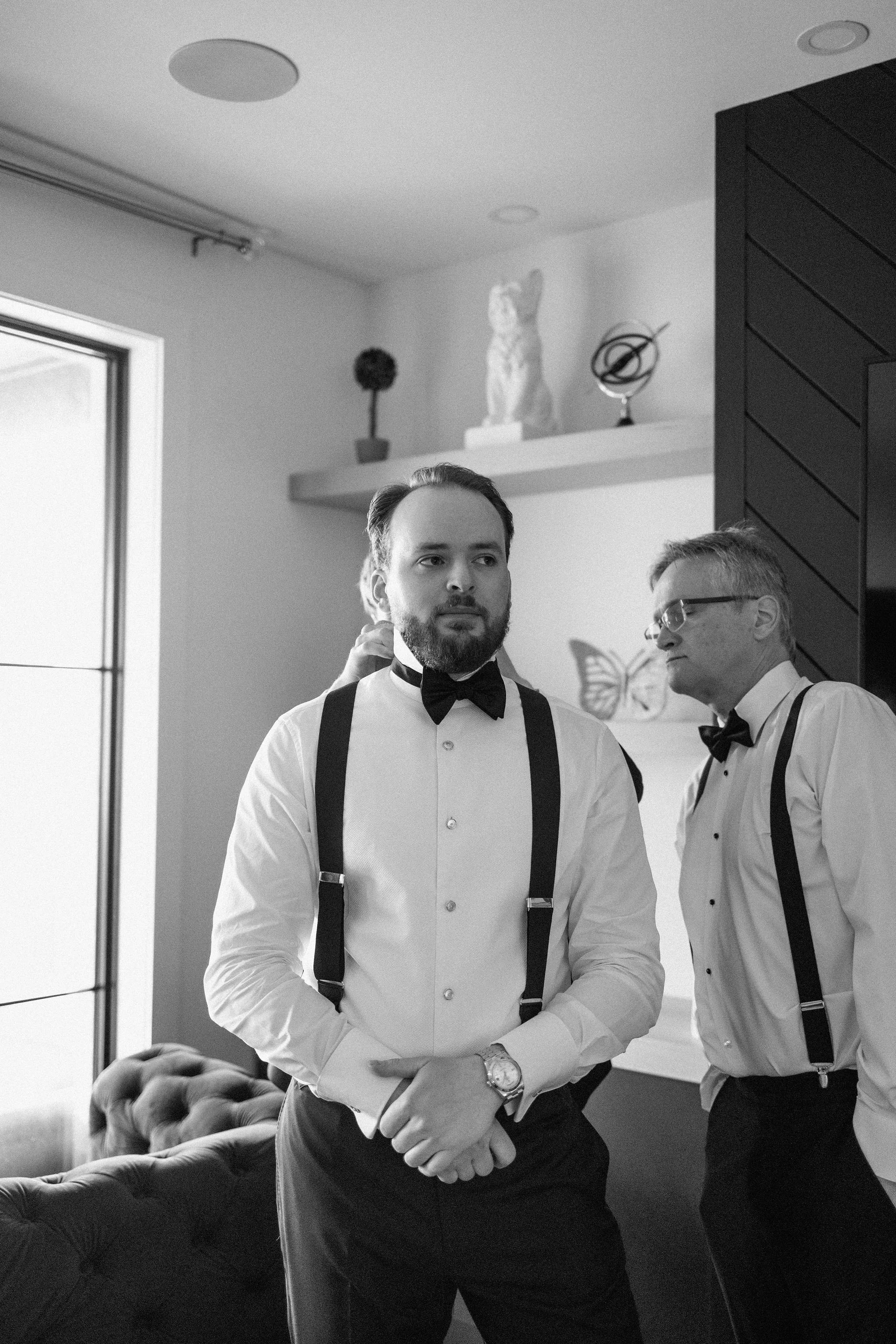  Groom getting ready for his outdoor tented wedding at The Clearing, London, Ontario. 