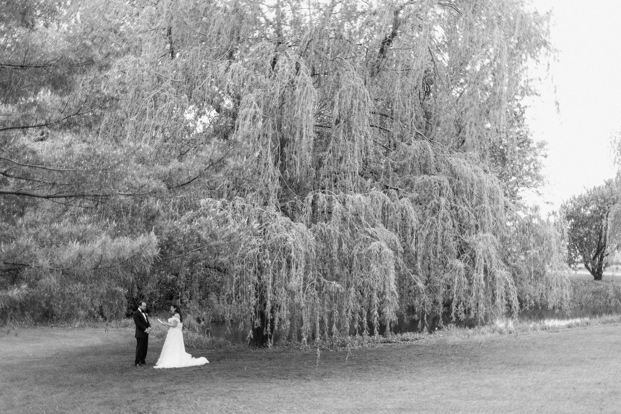  Whimsical first look took place under the willow trees on The Clearing property for their outdoor tented wedding. 