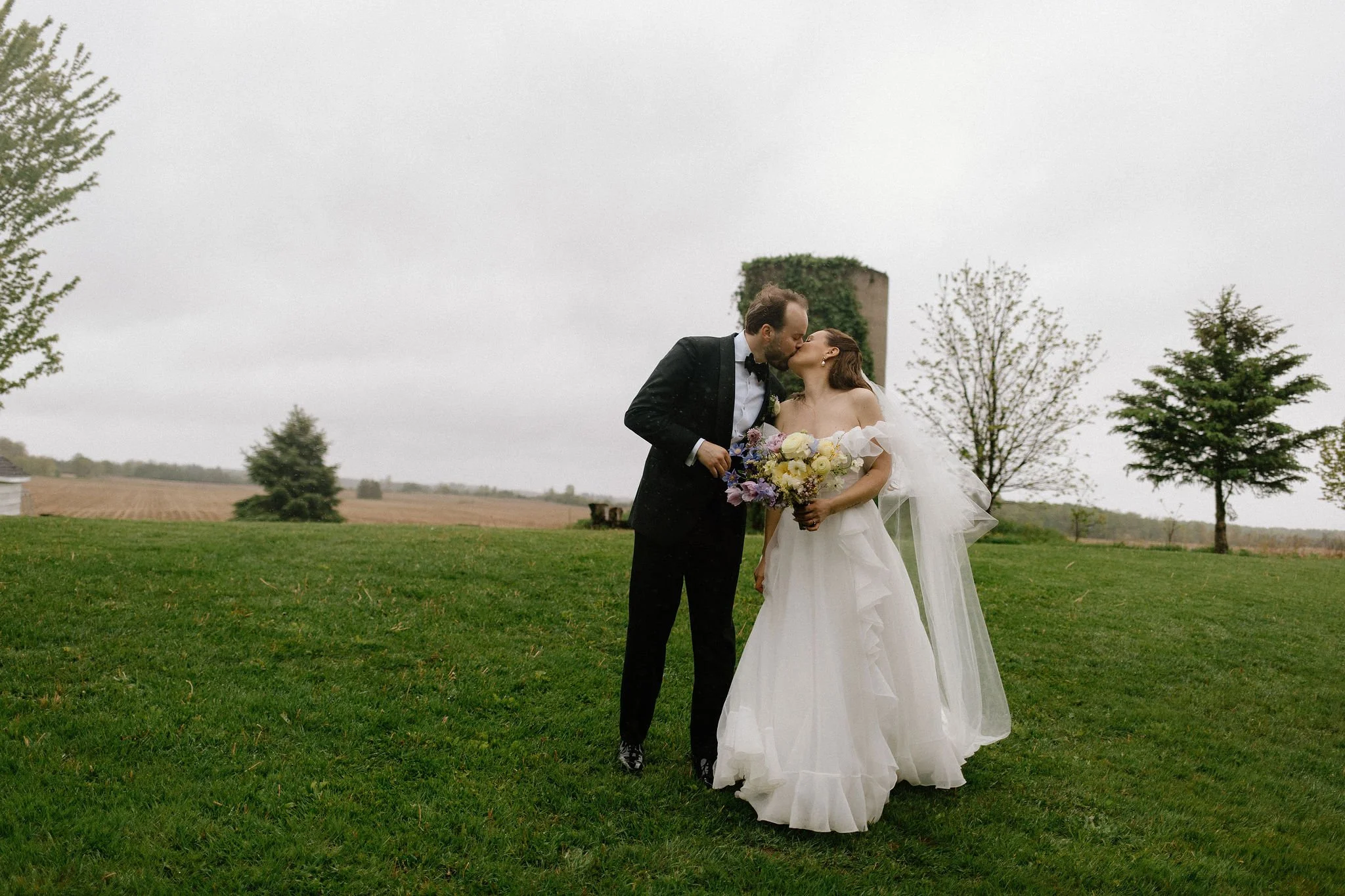  When the skies opened up for Lindsay and Matthew’s wedding at The Clearing, it didn't dampen the mood, instead, it set the stage for some of the most breathtaking portraits of the season. Working seamlessly with the overcast, dramatic lighting,  Joe