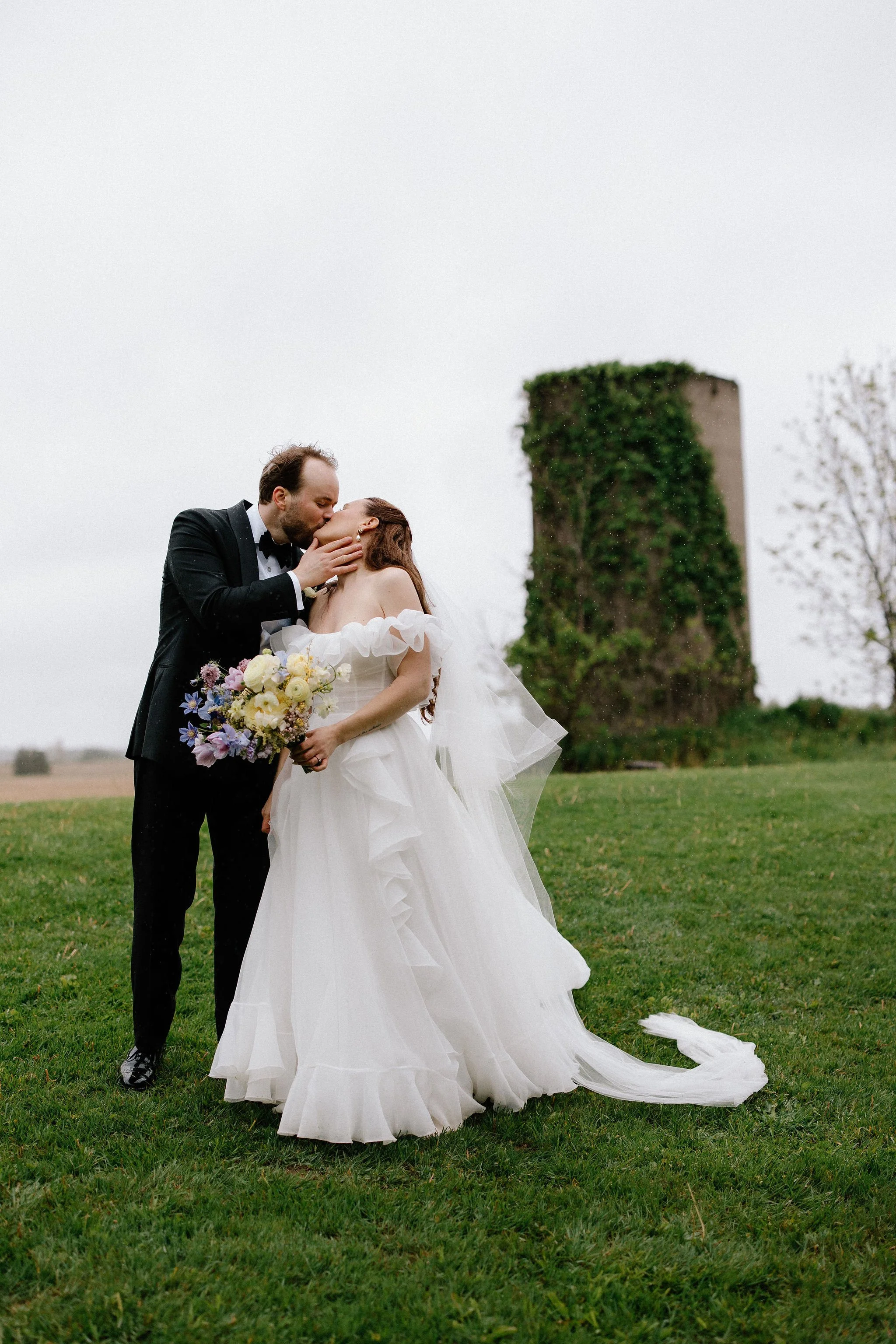  When the skies opened up for Lindsay and Matthew’s wedding at The Clearing, it didn't dampen the mood, instead, it set the stage for some of the most breathtaking portraits of the season. Working seamlessly with the overcast, dramatic lighting,  Joe