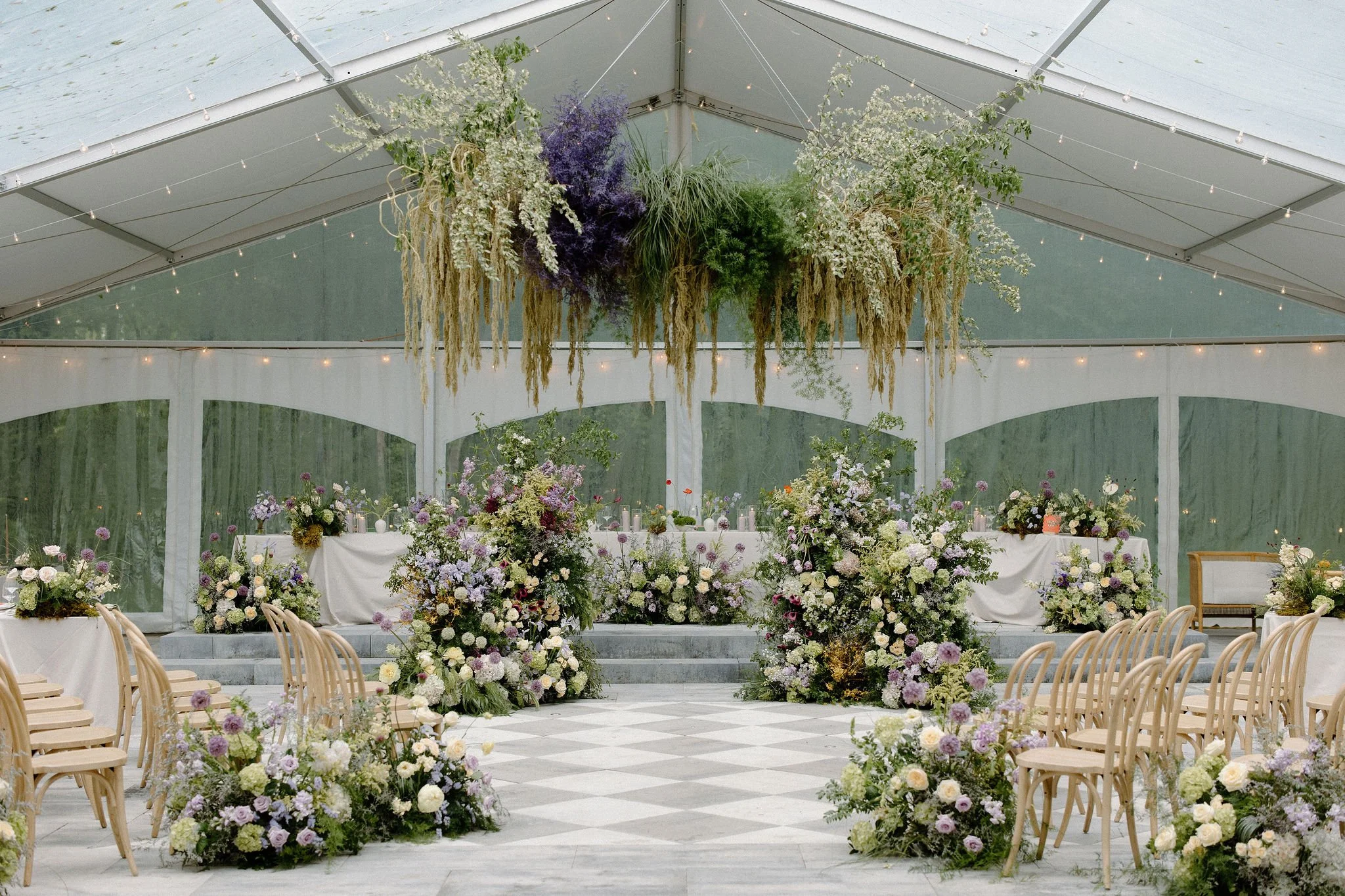  Proving that a little rain only adds to the romance, L+M’s wedding at The Clearing was an absolute dream. Nestled in the trees, this outdoor celebration embraced a whimsical garden aesthetic, brought to life by a vibrant, cheerful colour palette of 