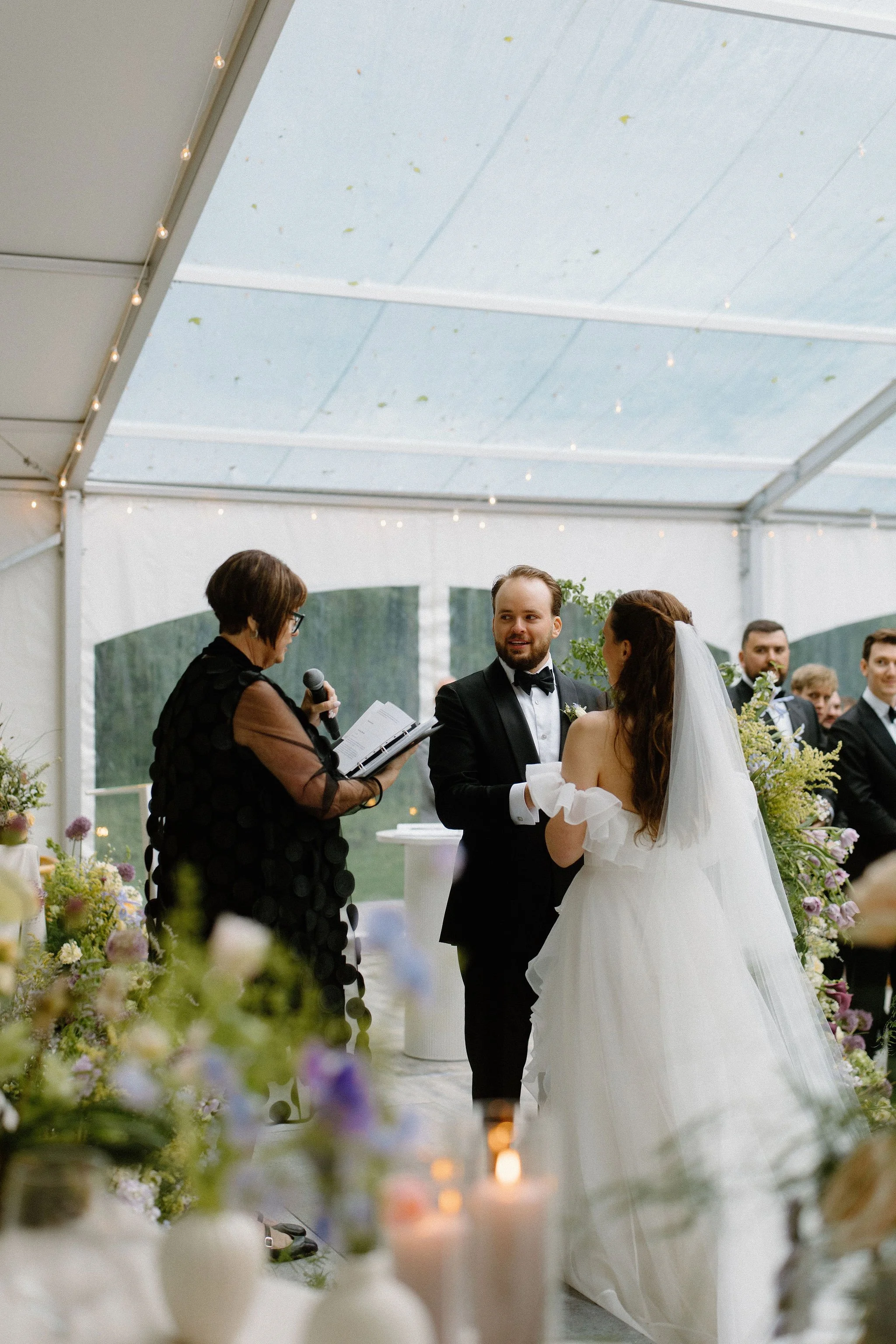 Bride and Groom share their vows infront of their guests under the clear top tent at The Clearing. 