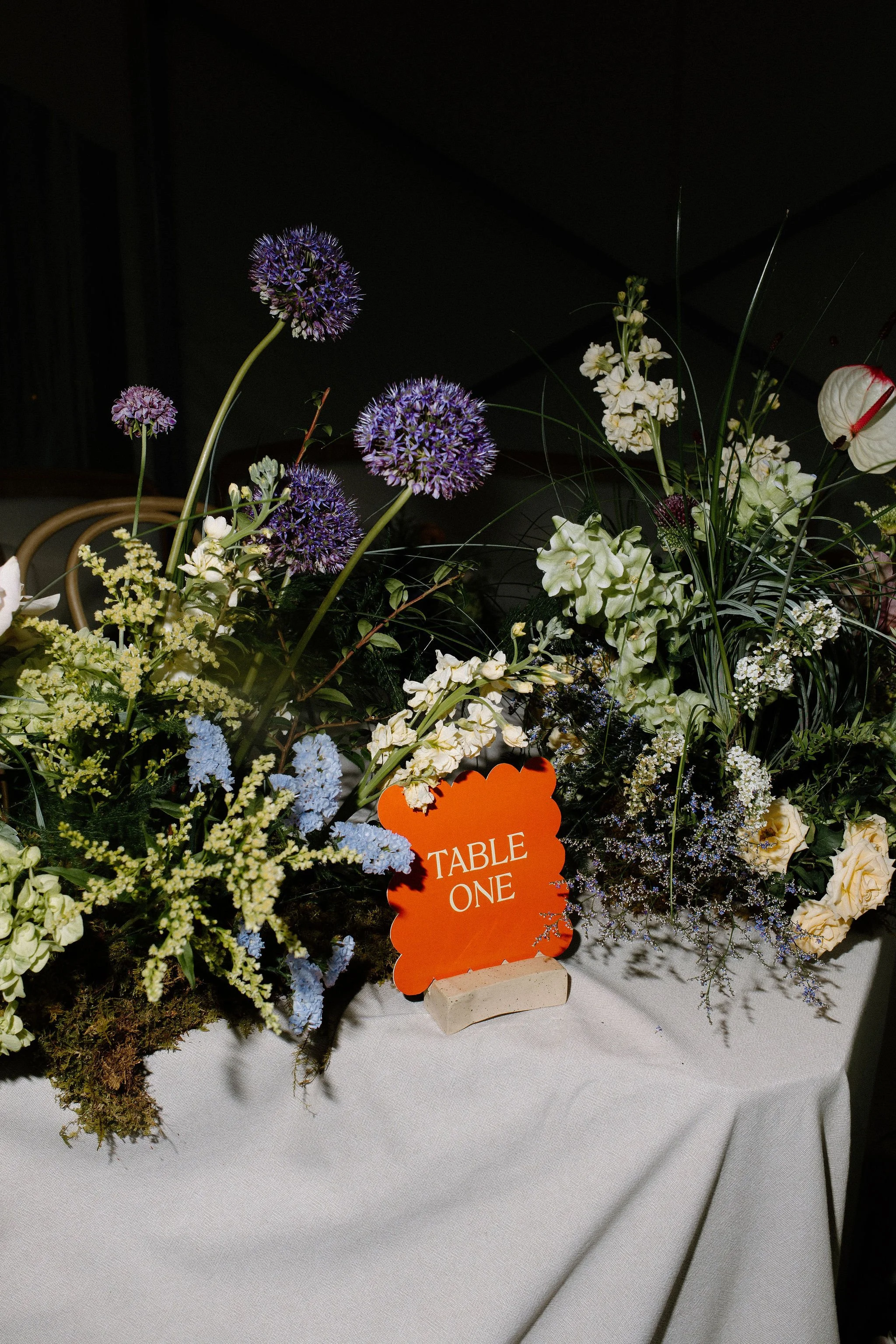  Floral meadows line the serpentine curved tables within the clear top tent at The Clearing. Florals by Forever Wildfield. 