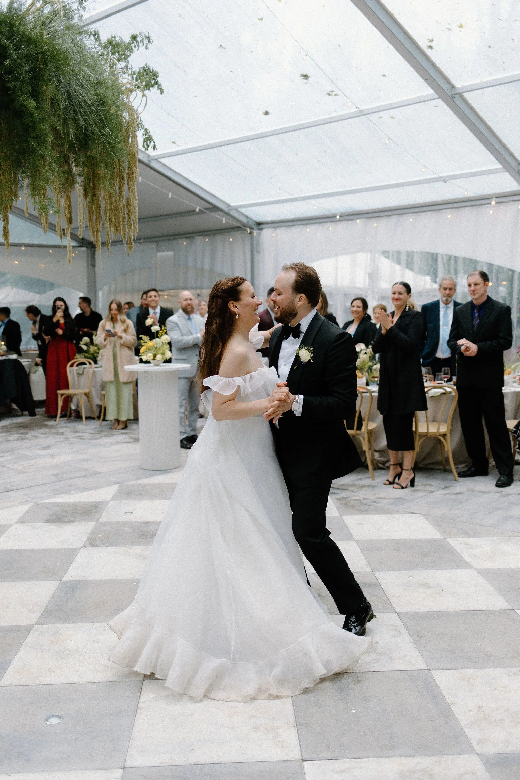  Proving that a little rain only adds to the romance, L+M’s wedding at The Clearing was an absolute dream. Nestled in the trees, this outdoor celebration embraced a whimsical garden aesthetic, brought to life by a vibrant, cheerful colour palette of 