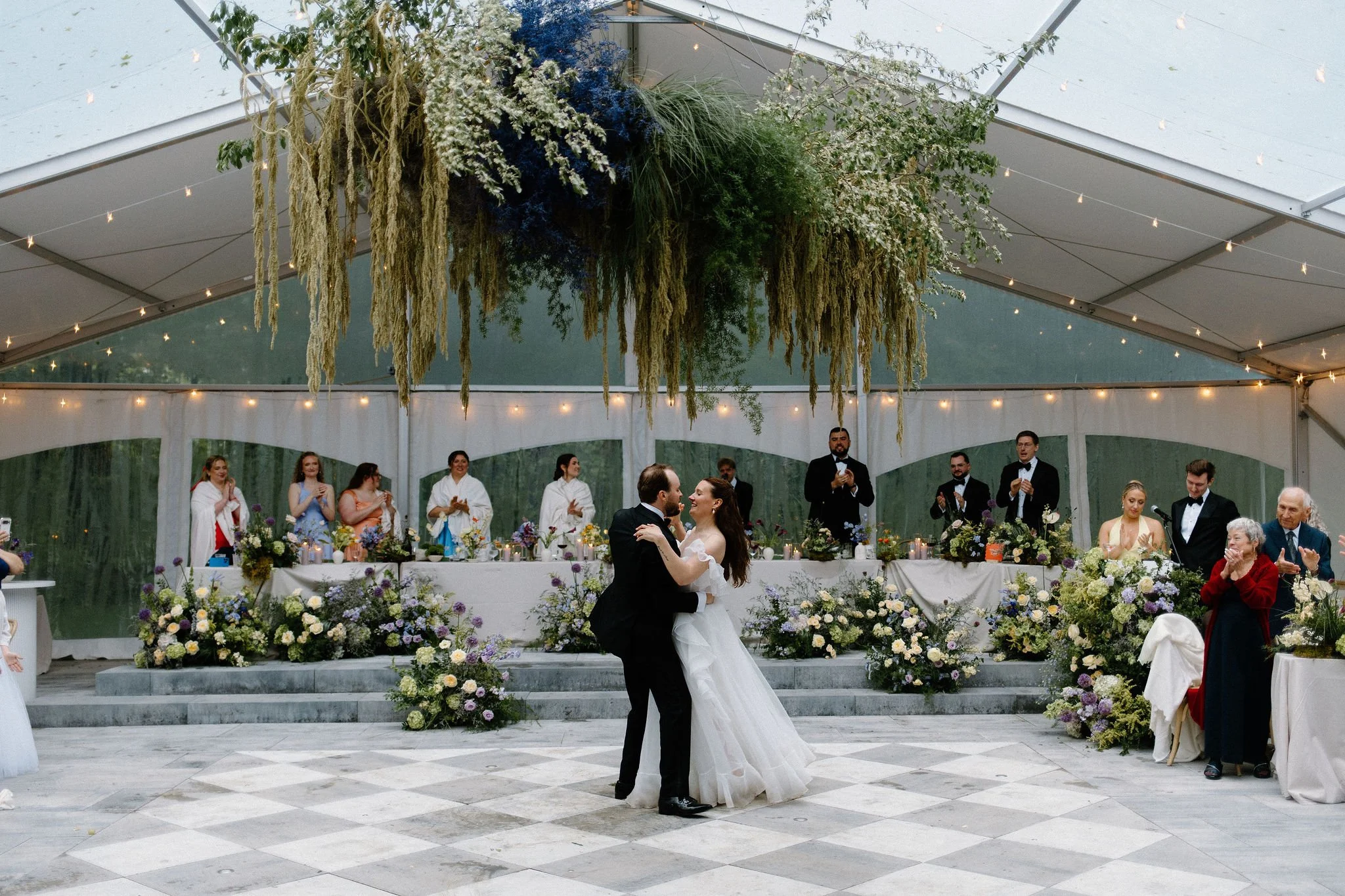  Bride and Groom share their first dance under the hanging floral installation at The Clearing. 