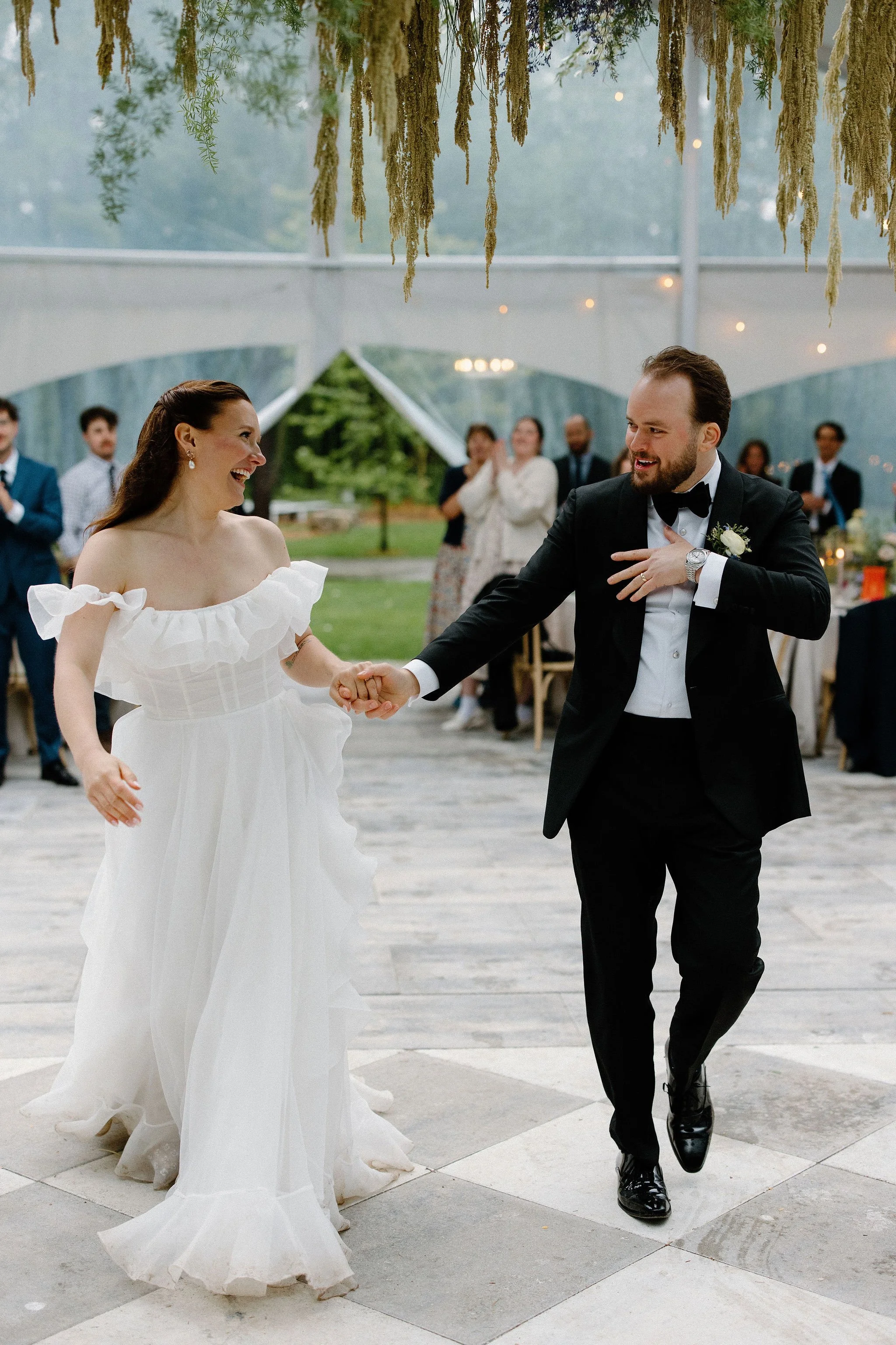  Bride and Groom dance their way into the wedding reception under the clear top tent at The Clearing.  