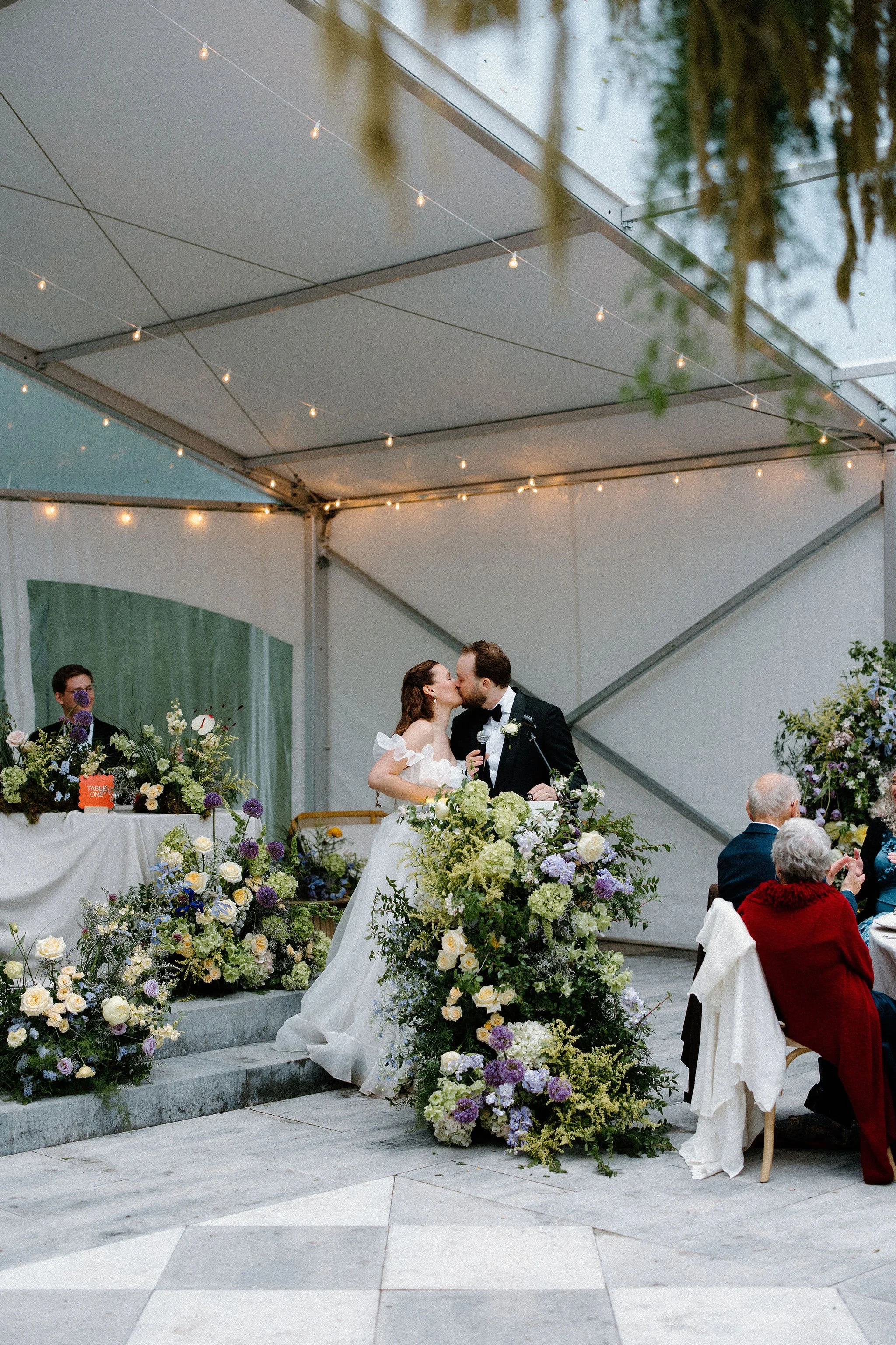  Step into this enchanting, rainy-day wedding gallery captured at The Clearing. Designed with a whimsical garden aesthetic, this outdoor celebration features a striking yellow and purple colour palette that perfectly countered the rainy skies. Explor