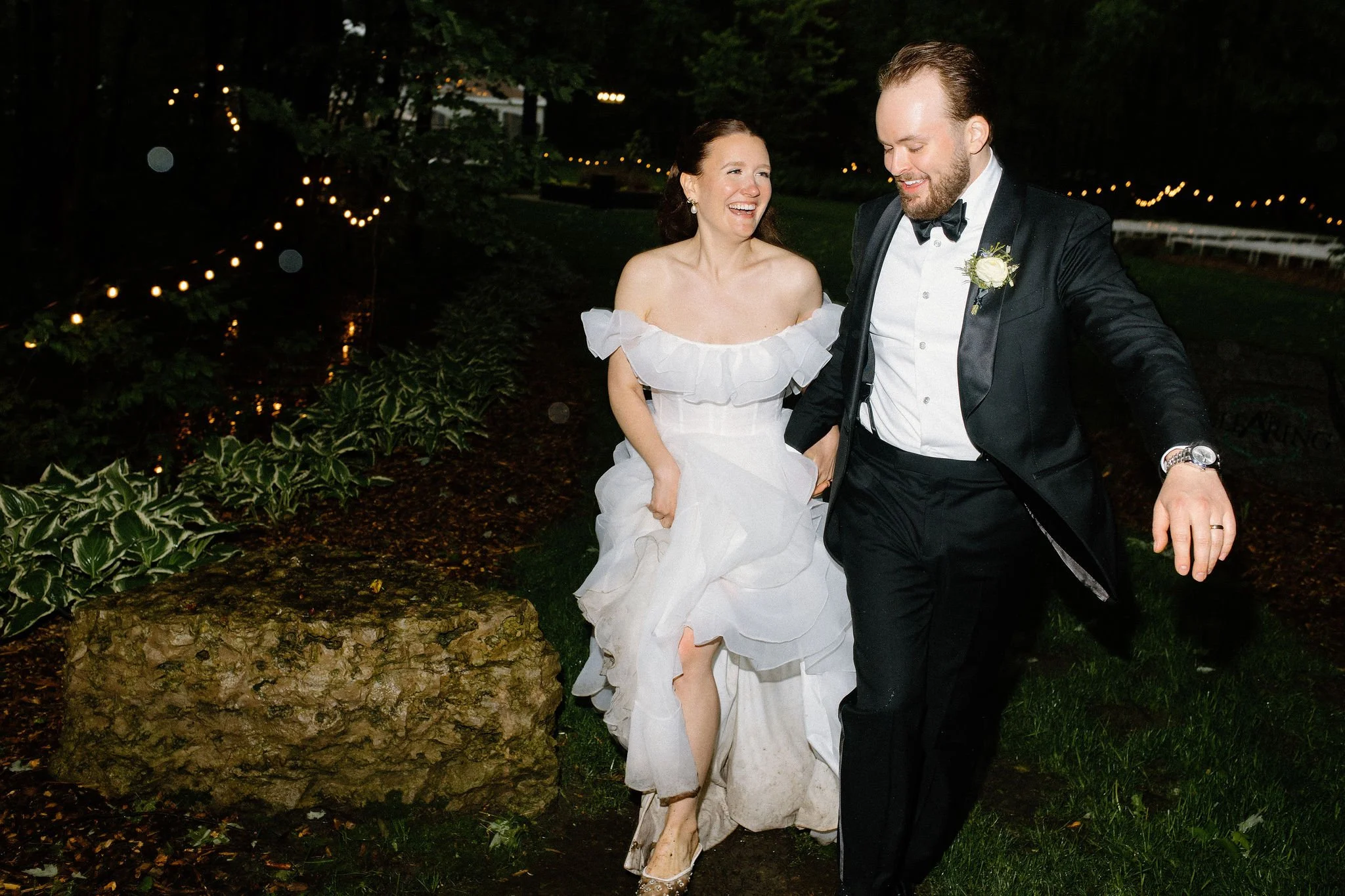  When it rains on your wedding day, you play in the puddles! After the sun went down at The Clearing, we headed outside into the dark for some epic rainy night portraits. These playful shots of L+M splashing in the puddles under the moody sky are pro
