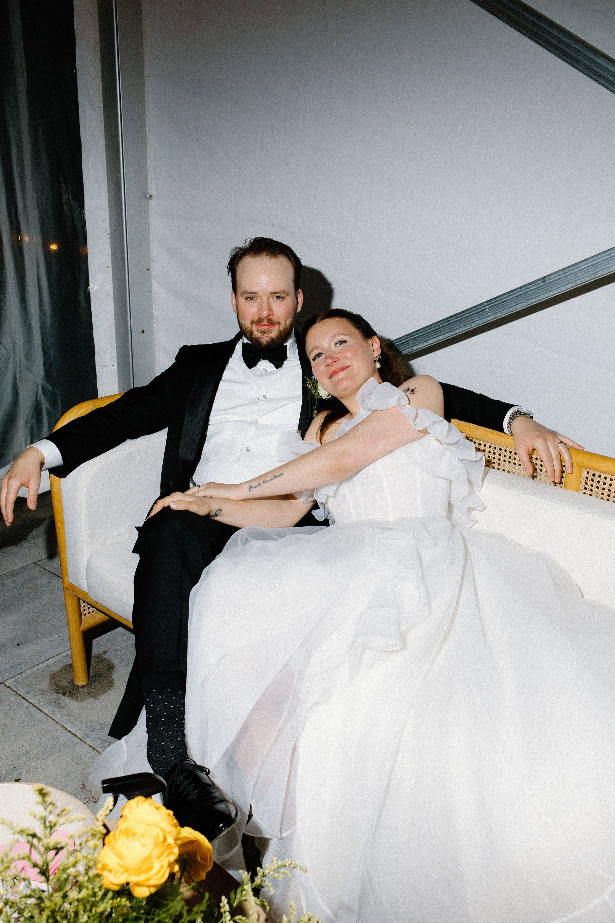  Bride and Groom enjoy their lounge set under the clear top tent and twinkle lights to their tented wedding at The Clearing, Sheddon, Ontario. 
