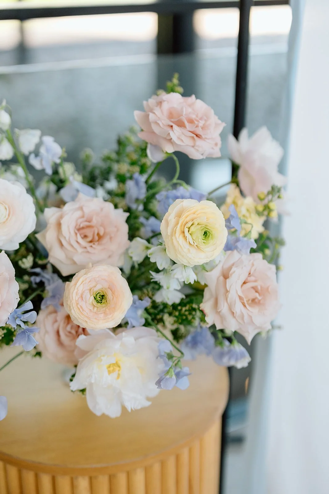  Airy, delicate arrangements featuring soft pink ranunculus, open white peonies, and whimsical pops of light blue delphinium created a "just-picked-from-the-garden" feel. Curated by Simply Elegant by Emma 