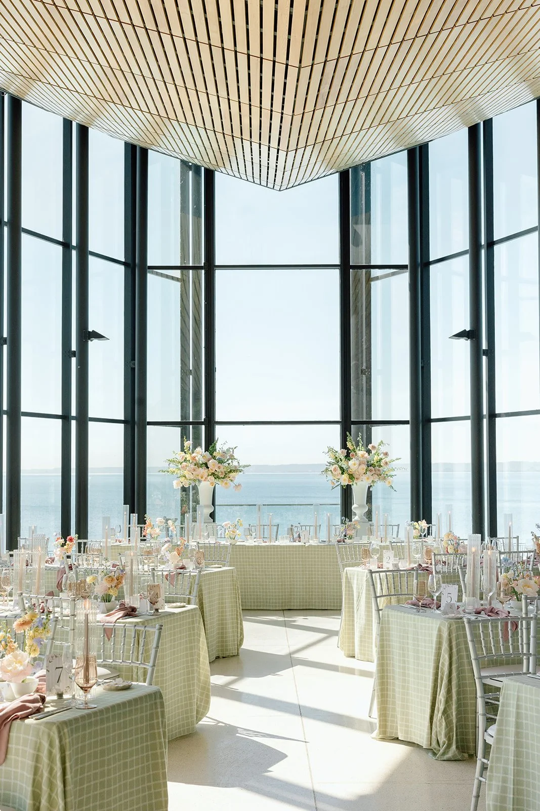  A breathtaking wide shot of the sun-drenched dining room at Spencer's at the Waterfront, showcasing the full room layout and Lake Ontario backdrop. 